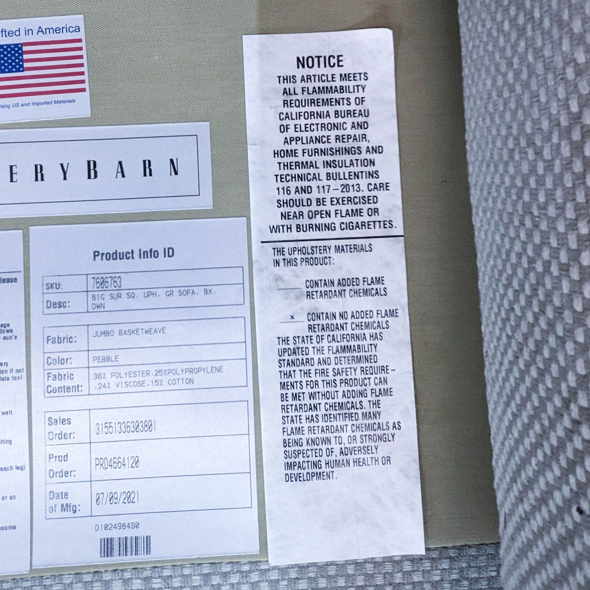 Alt text: Close-up of Pottery Barn product label for a 3-seat Big Sur sofa, indicating fabric details and flammability notice.