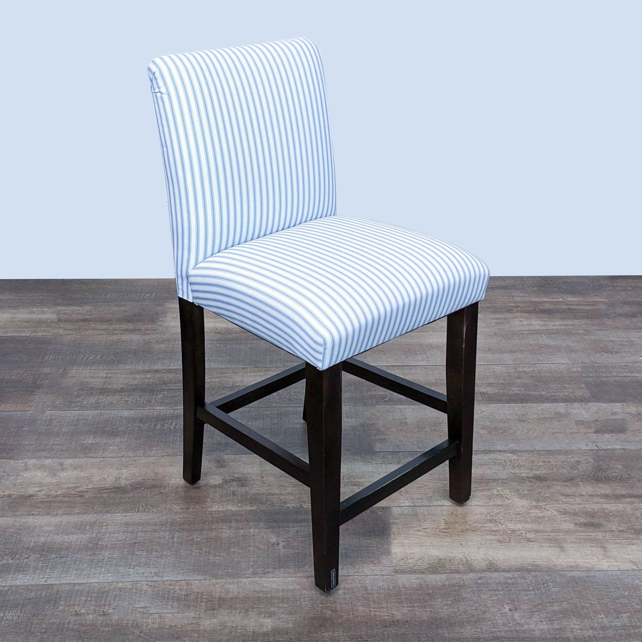Striped fabric counter stool on solid wood legs, dark finish, by Skyline Furniture.