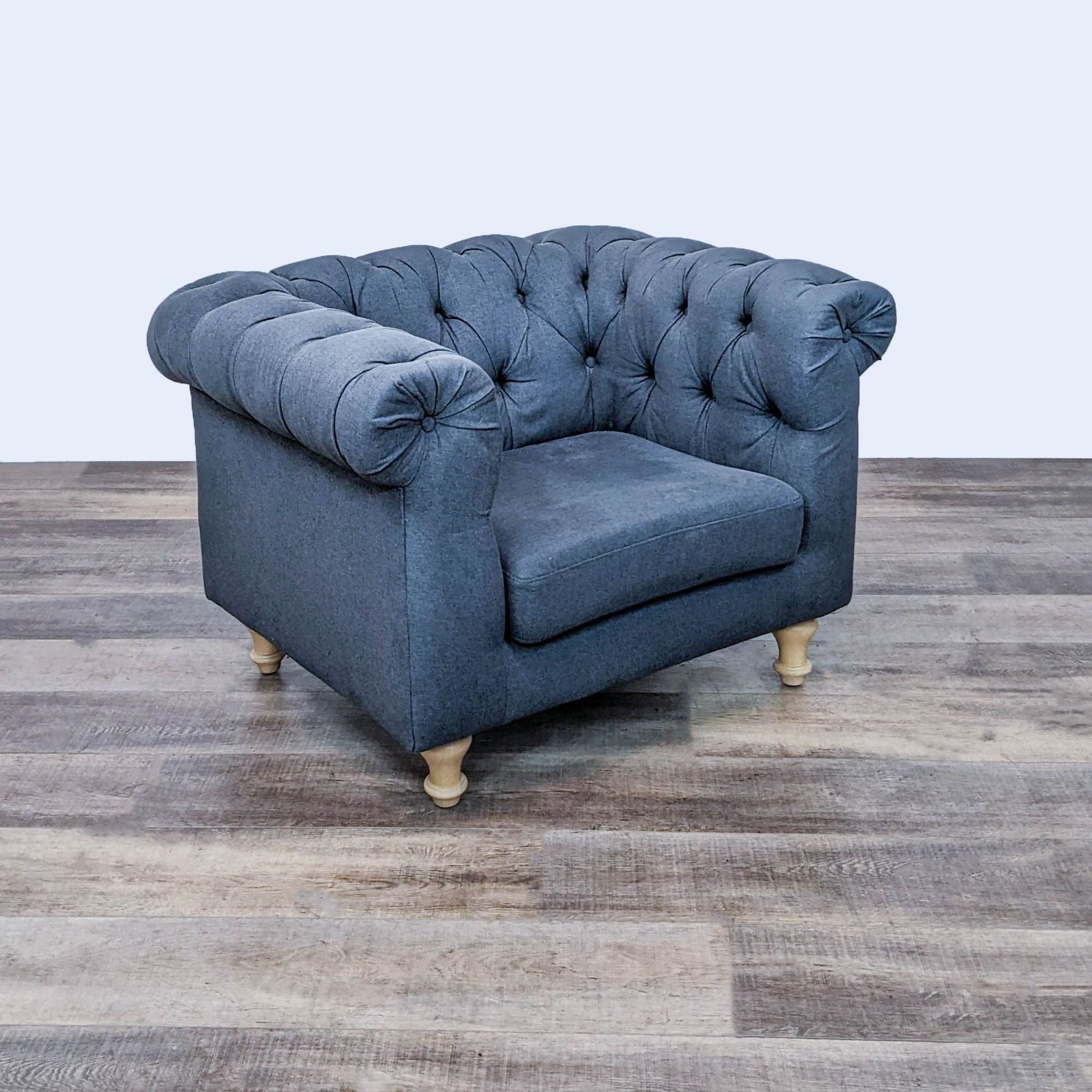 World Market club chair with rolled arms, turned wood feet, and button-tufted fabric upholstery.