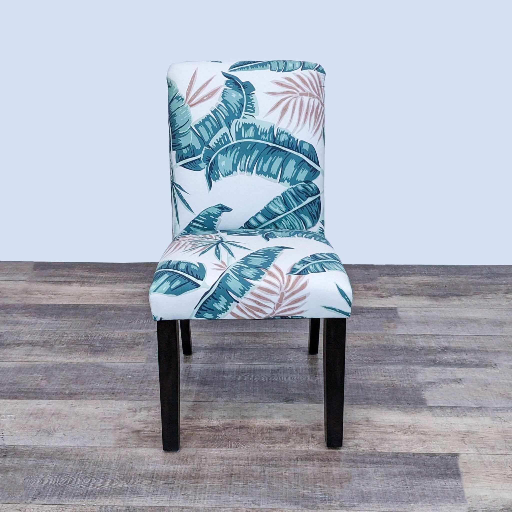 Skyline Furniture Hendrix chair with tapered wood legs, palm leaf print, and piping detail, suitable for dining rooms.
