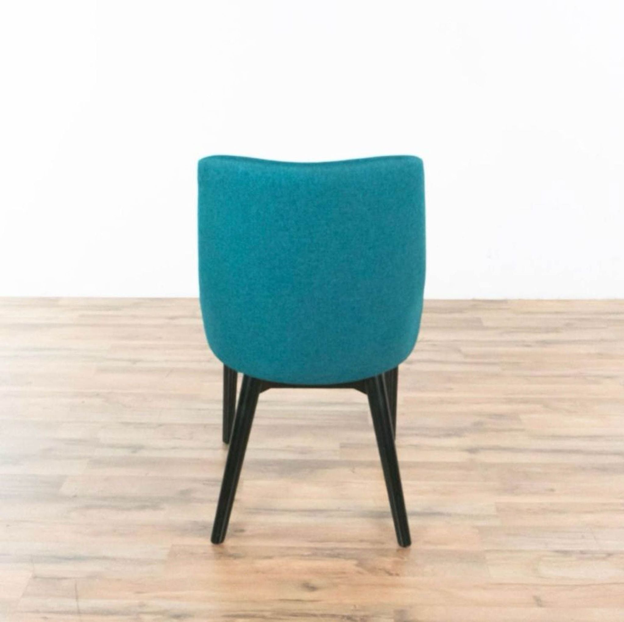 Modern StealMod Viscount side chair with teal upholstery and black tapered wood legs.