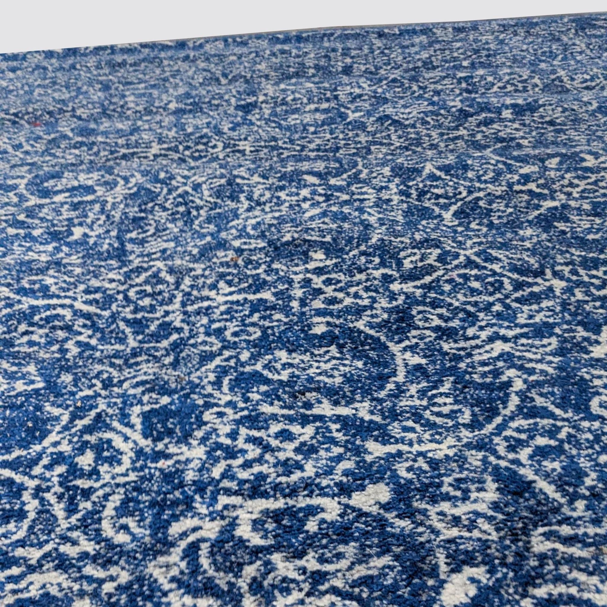 Close-up of nuLOOM Waddell Vintage Dark Blue area rug showcasing its Oriental design, texture, and color variations in low pile.