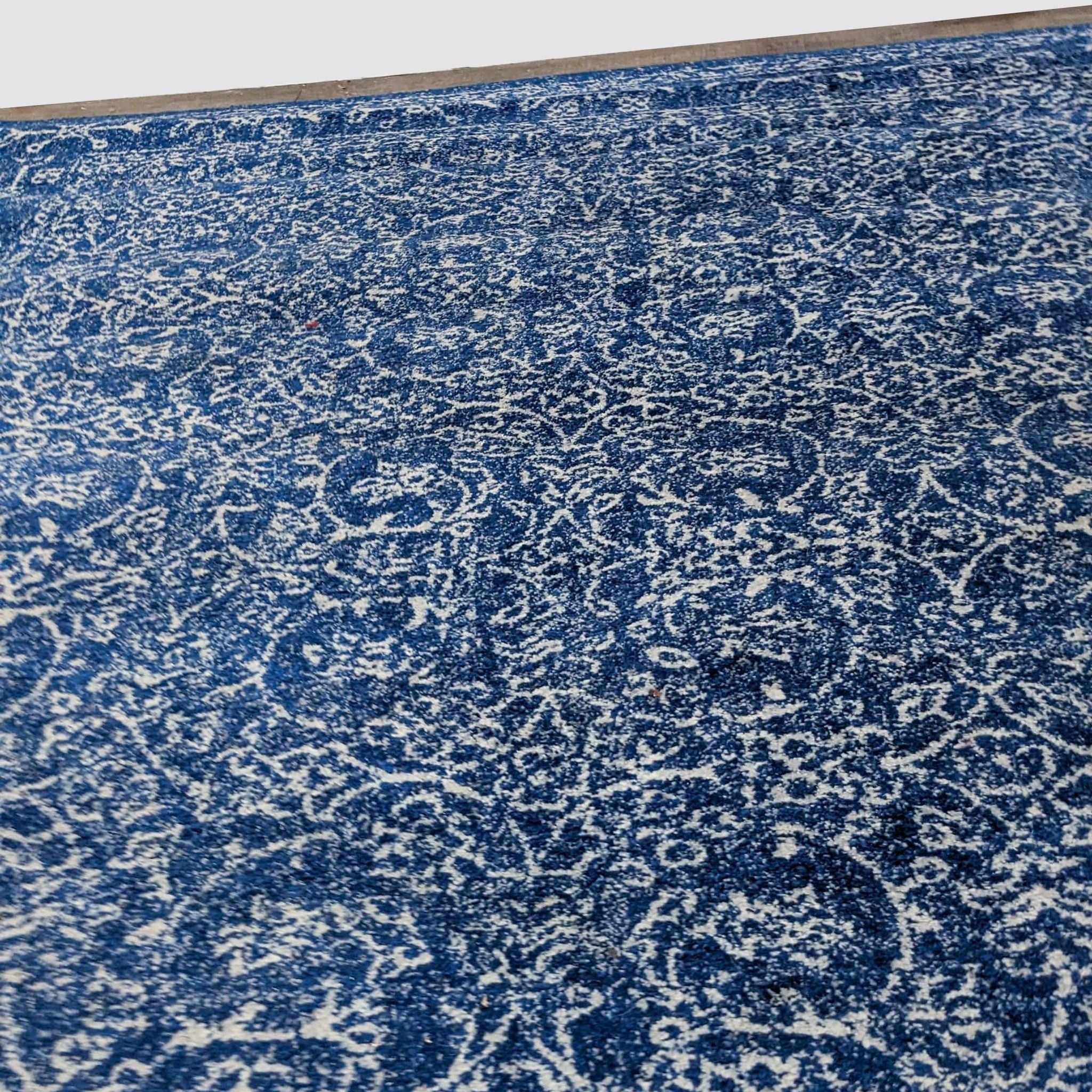 Dark blue nuLOOM Waddell Vintage area rug with Oriental pattern, 6’7”x9’, low pile, displayed on floor.