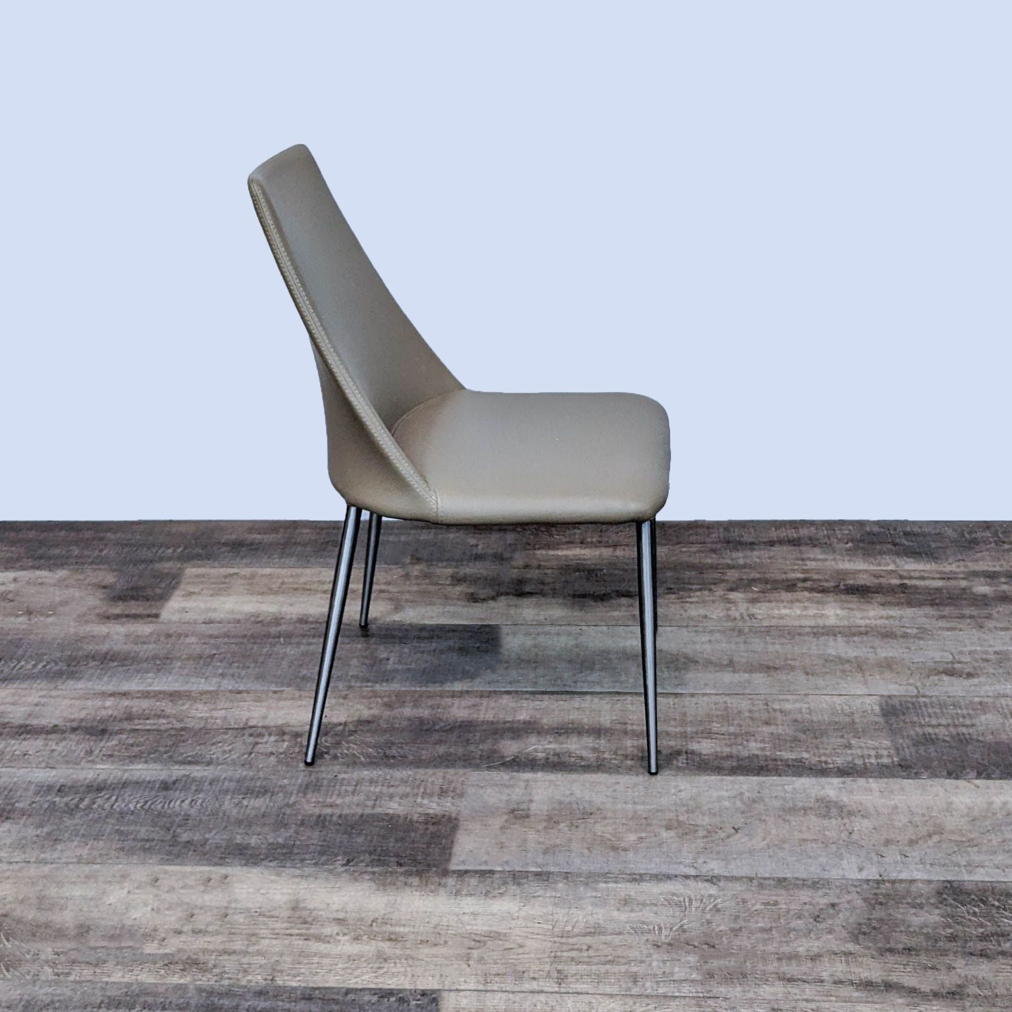 Alt text 2: Side view of a Zuo Modern Whisp dining chair showcasing its wingback style and sleek chrome legs on a wooden floor.
