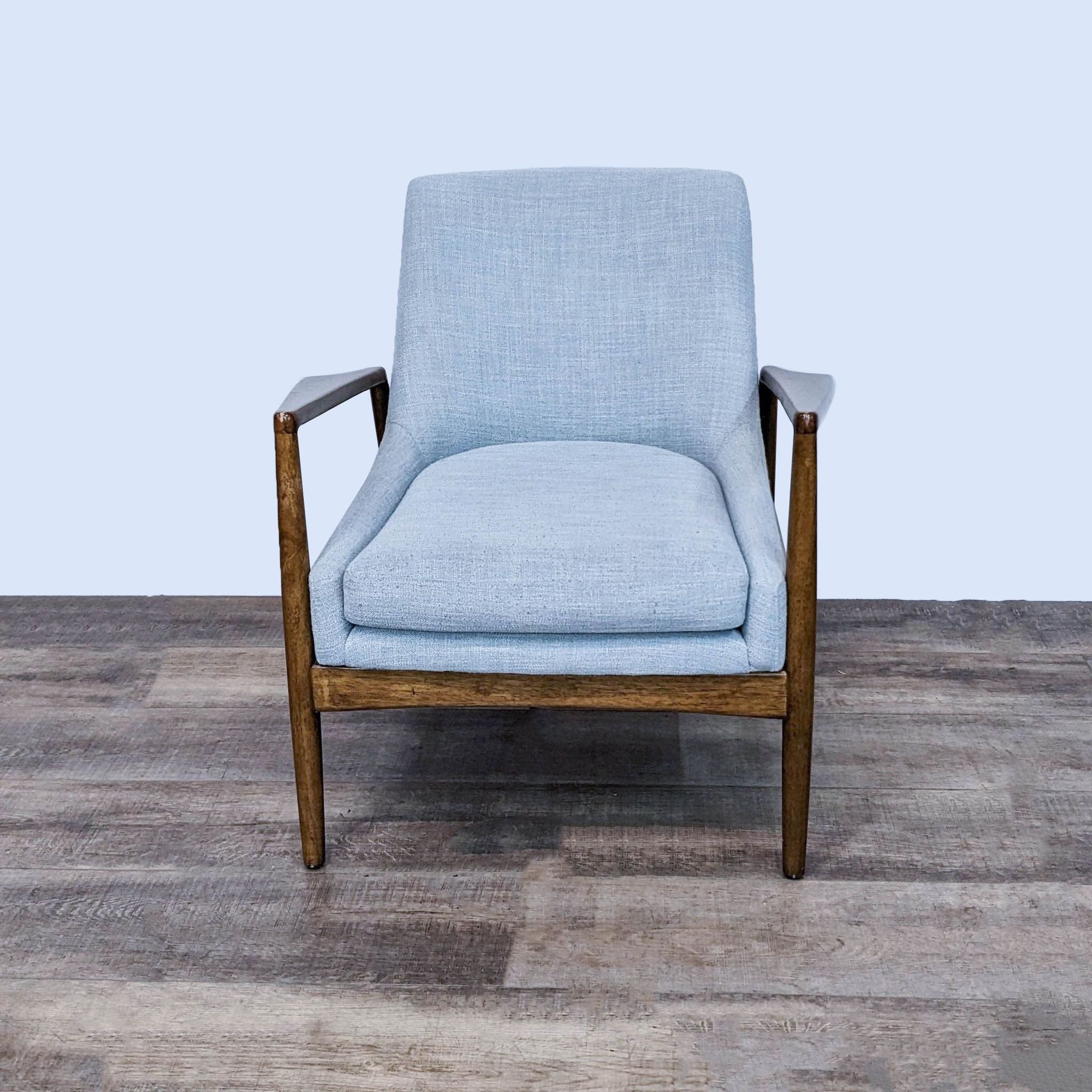 Alt text 1: Prescott Accent Chair by Madison Park with light blue upholstery and solid wood frame in a brown finish, front view on wood floor.
