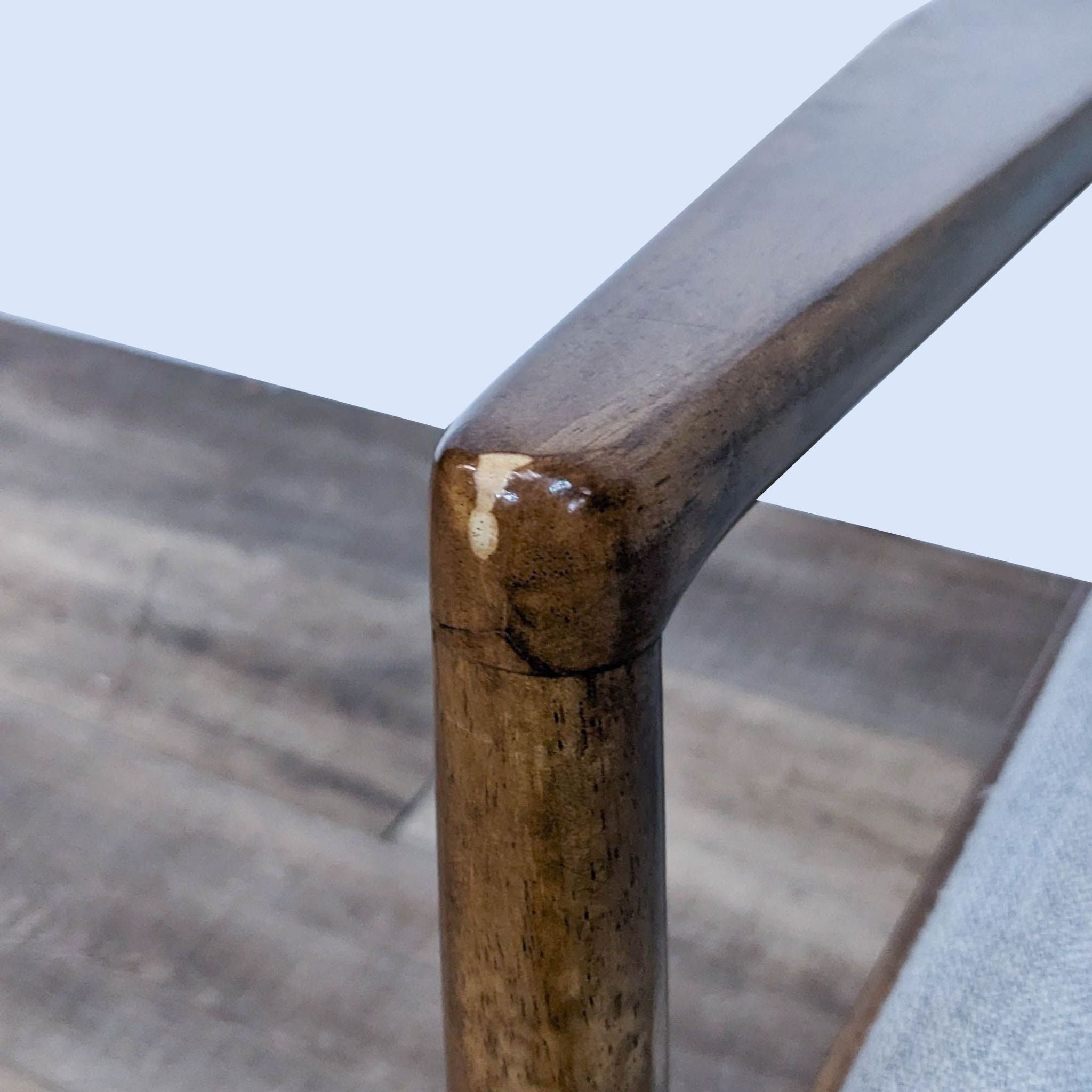 Close-up of the Prescott Accent Chair's wooden arm with brown finish by Madison Park showing detail and texture.