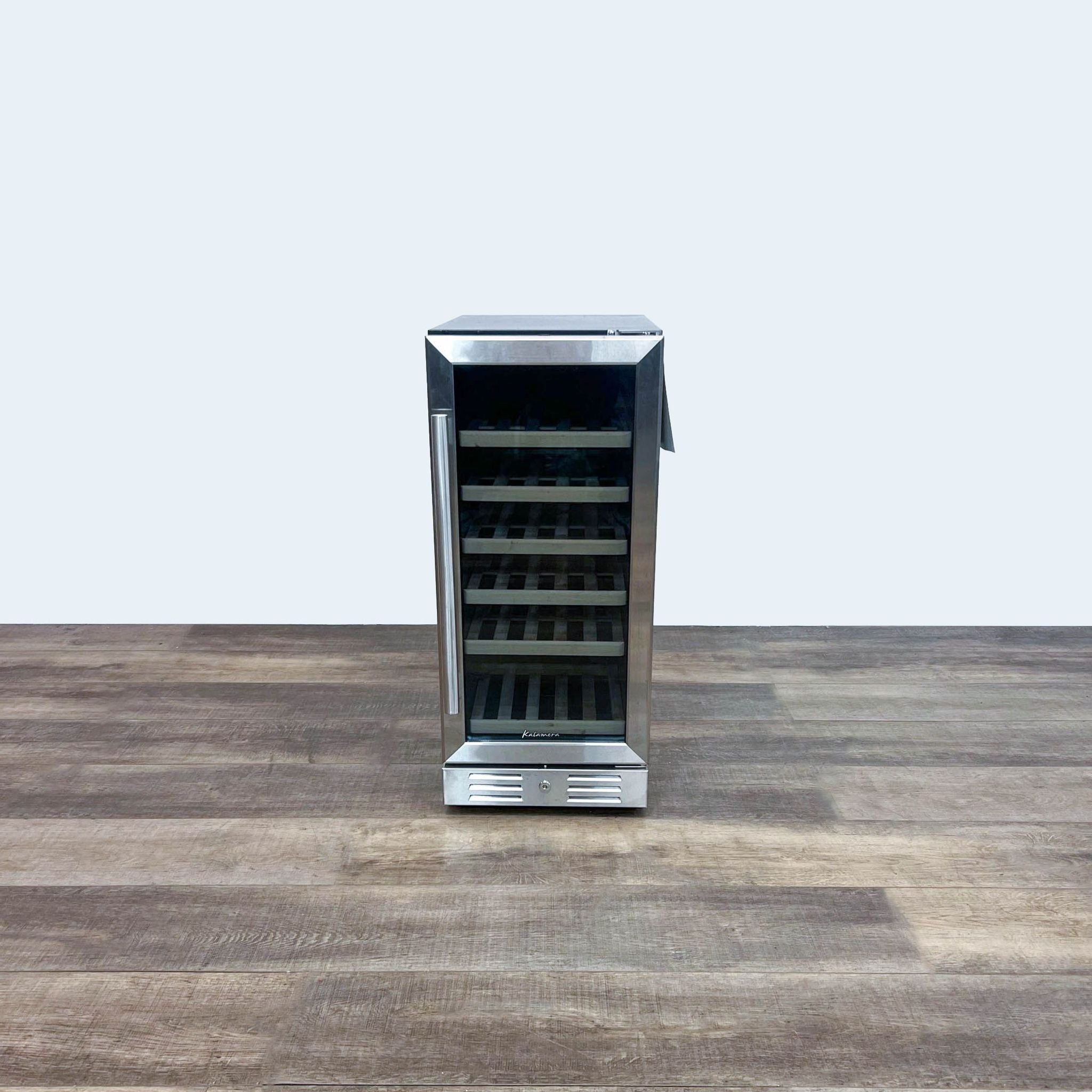 1. Stainless steel Kalamera beverage refrigerator with glass door open and wooden shelves, on a wooden floor against a white wall.