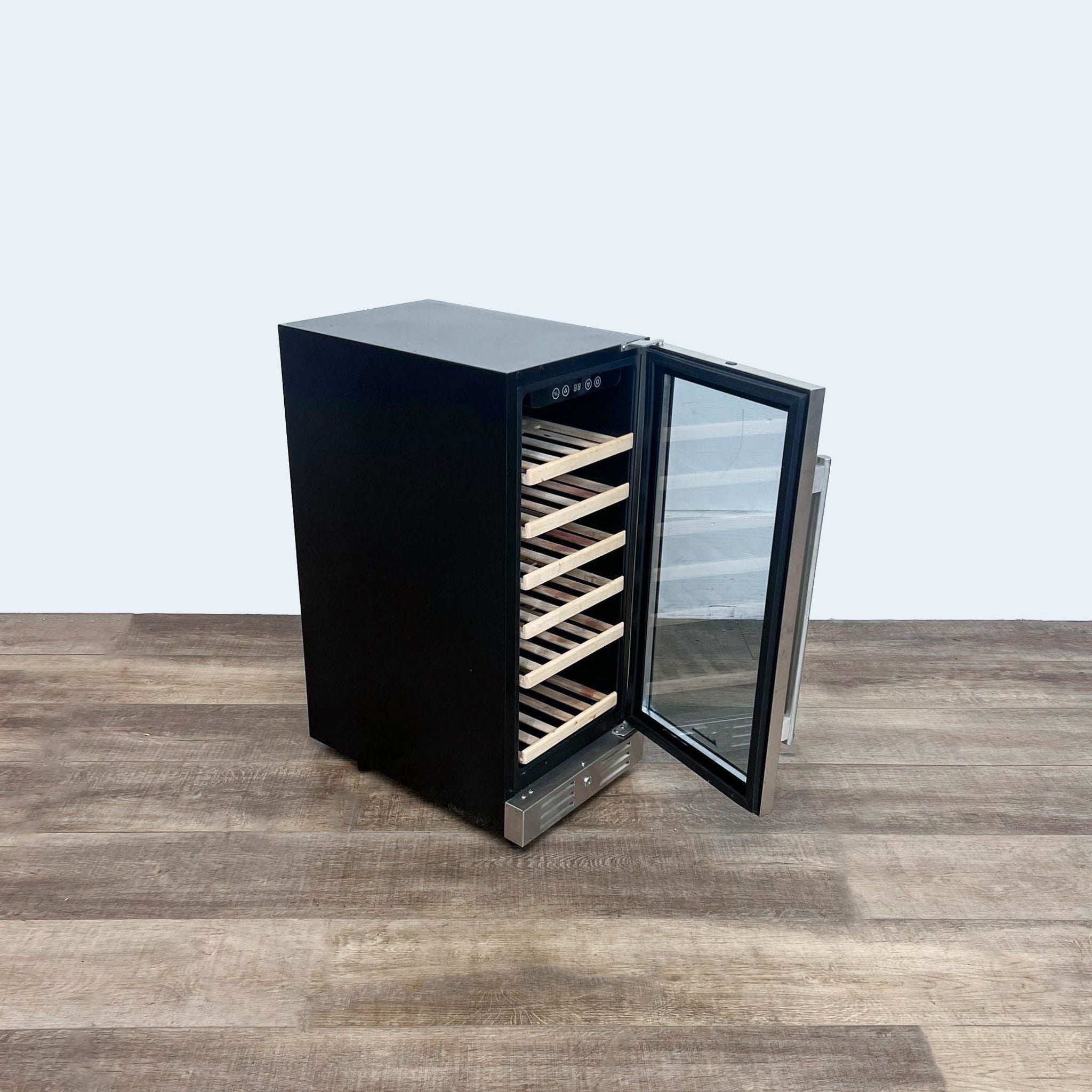 2. Black Kalamera wine cooler with digital temperature display and open glass door revealing wooden shelves, placed on a wooden floor.