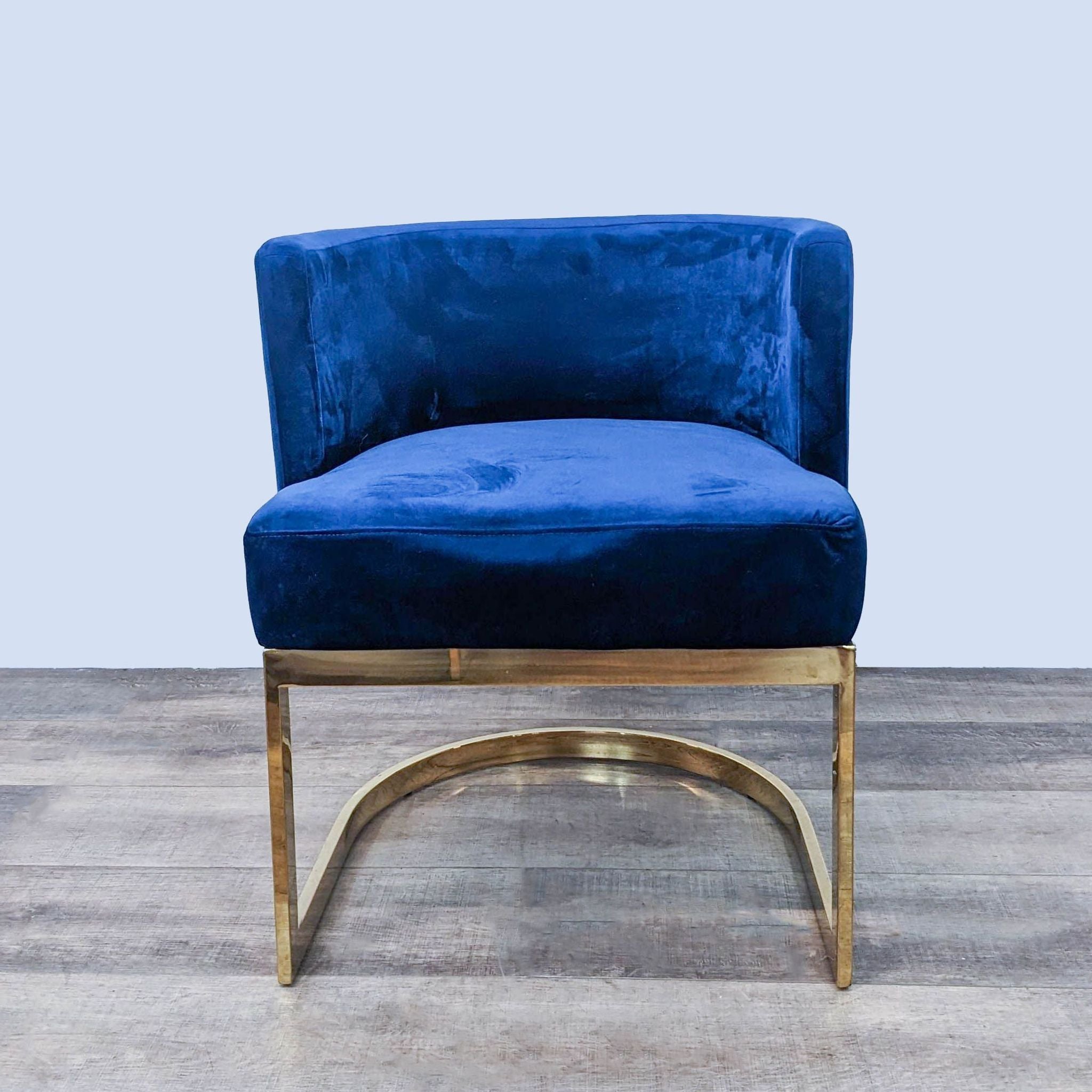 Plush navy blue velvet dining chair by Meridian Furniture with a U-shaped gold stainless steel base.