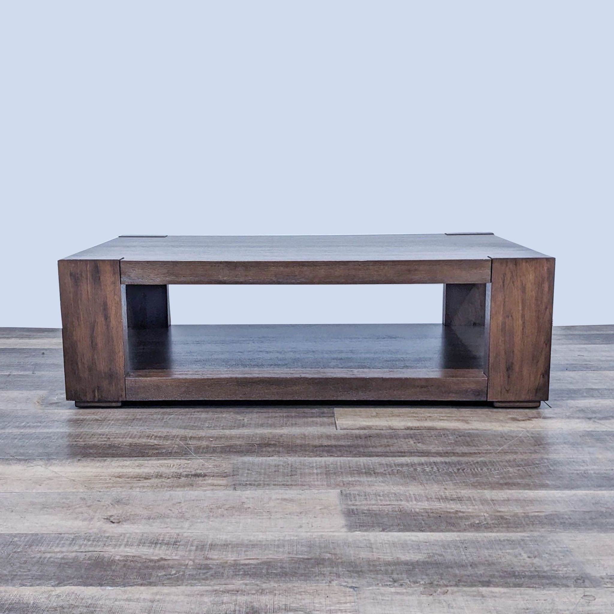 Crate & Barrel coffee table with hand-planed, wire-brushed walnut veneer surface, on hardwood floor.