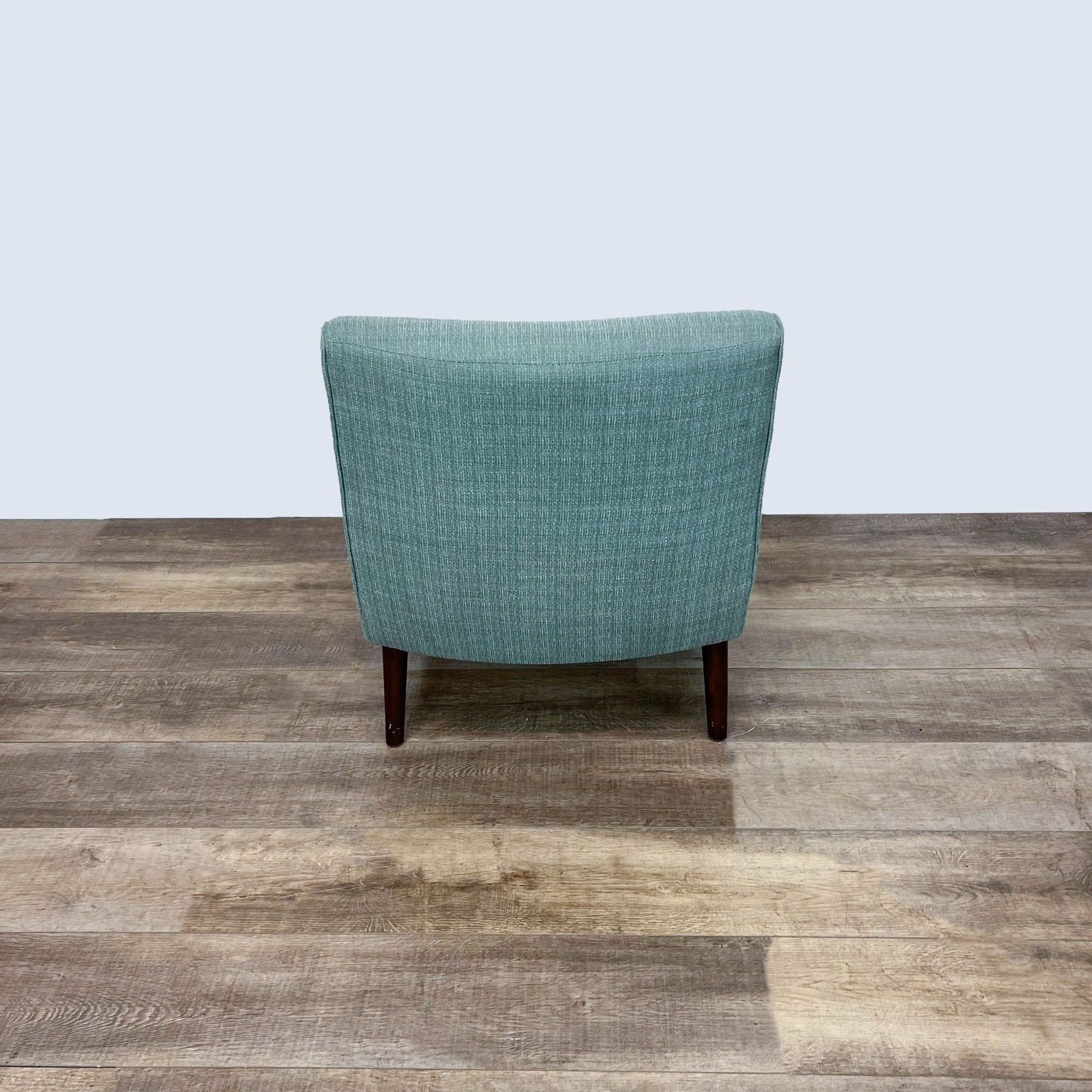 Madison Park Liam Chair with angled rubberwood legs, plywood-hardwood frame, and teal upholstered high-density foam on a wood floor.