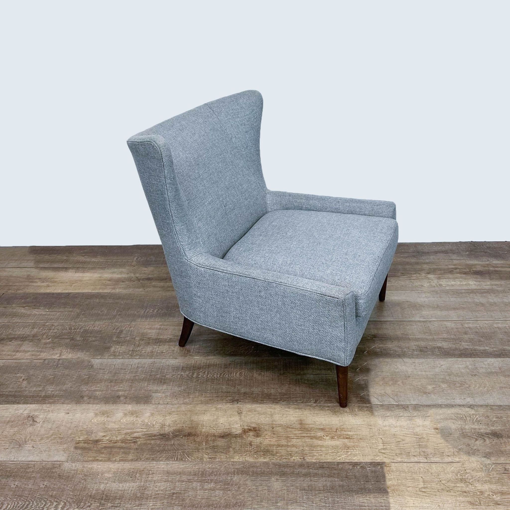 Side and rear angles of Four Hands' Marlow chair, displaying the elegant wingback style, gray upholstery, and dark wood legs.