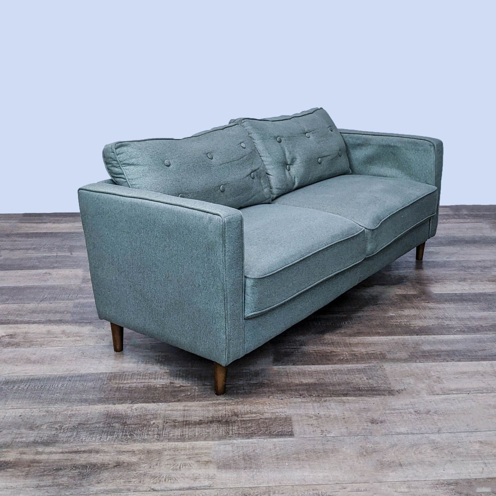 Front angle view of Zinus 3-seat sofa showcasing buttoned upholstery and piped edges in a minimalistic setting.