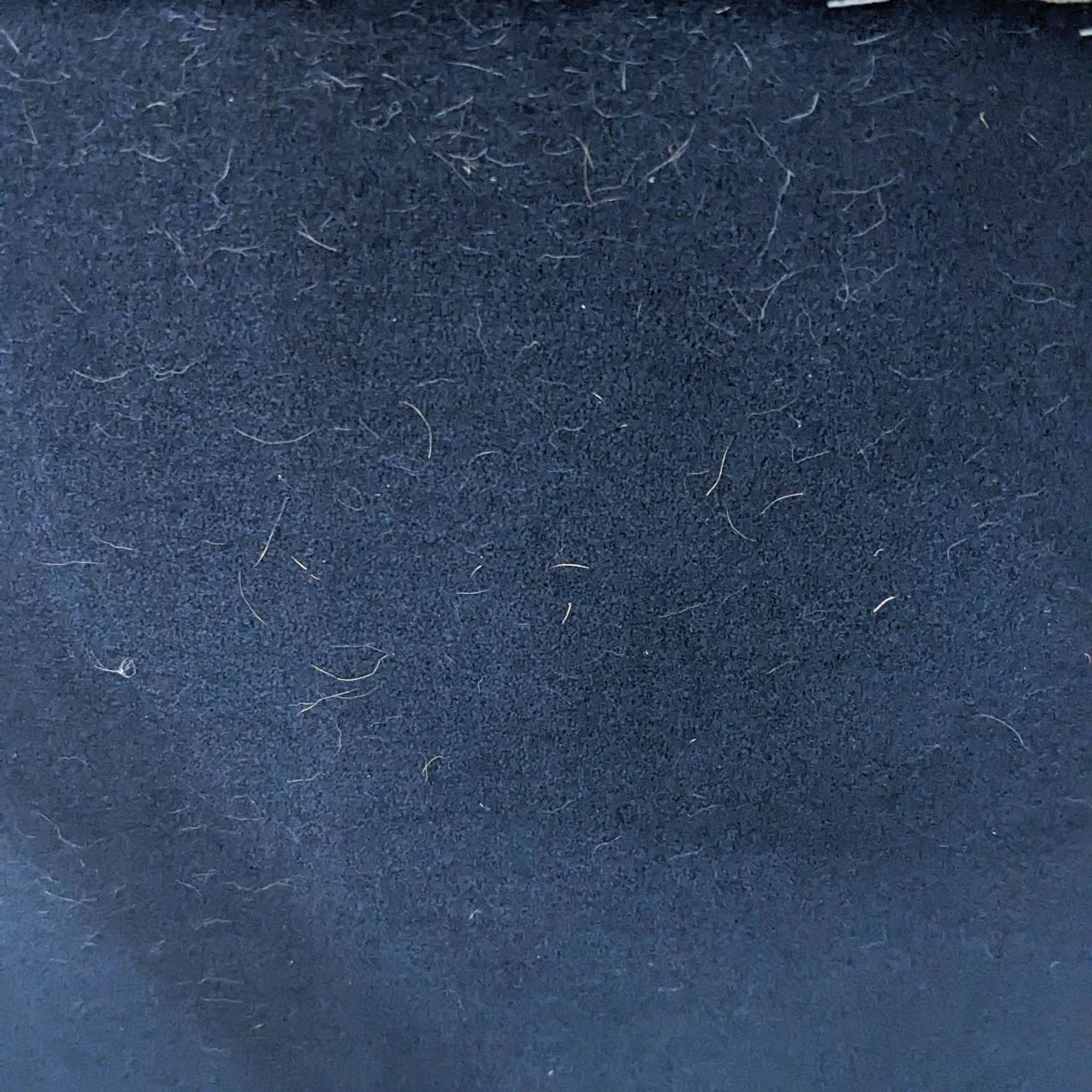 Close-up texture of microfiber upholstery, possibly from a Sharelle Elite Collection dining chair.