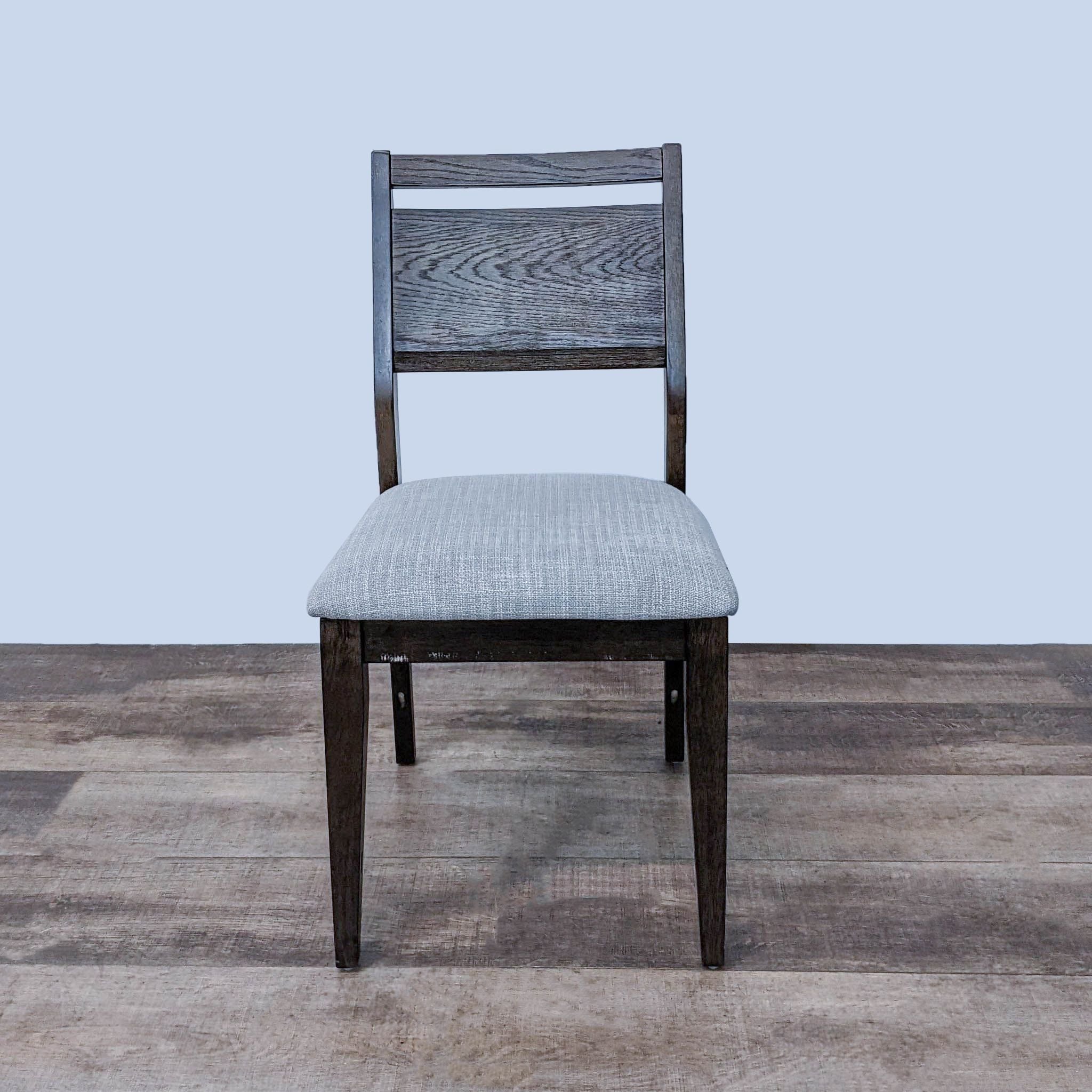 Reperch contemporary dining chair with dark wood frame and gray upholstered seat.