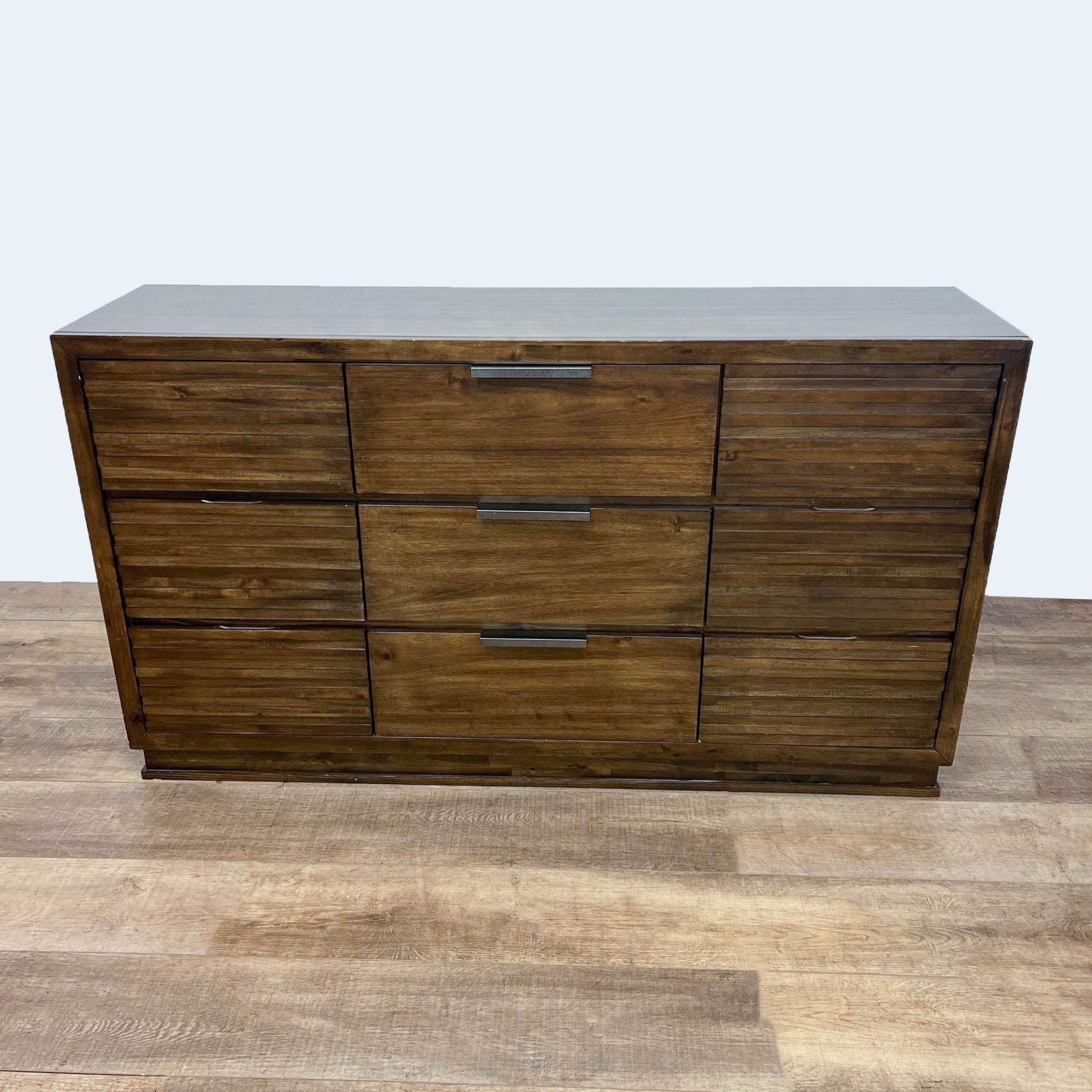 Walnut finish 6-drawer dresser by Furniture of America with wood grain details and metal pull handles.