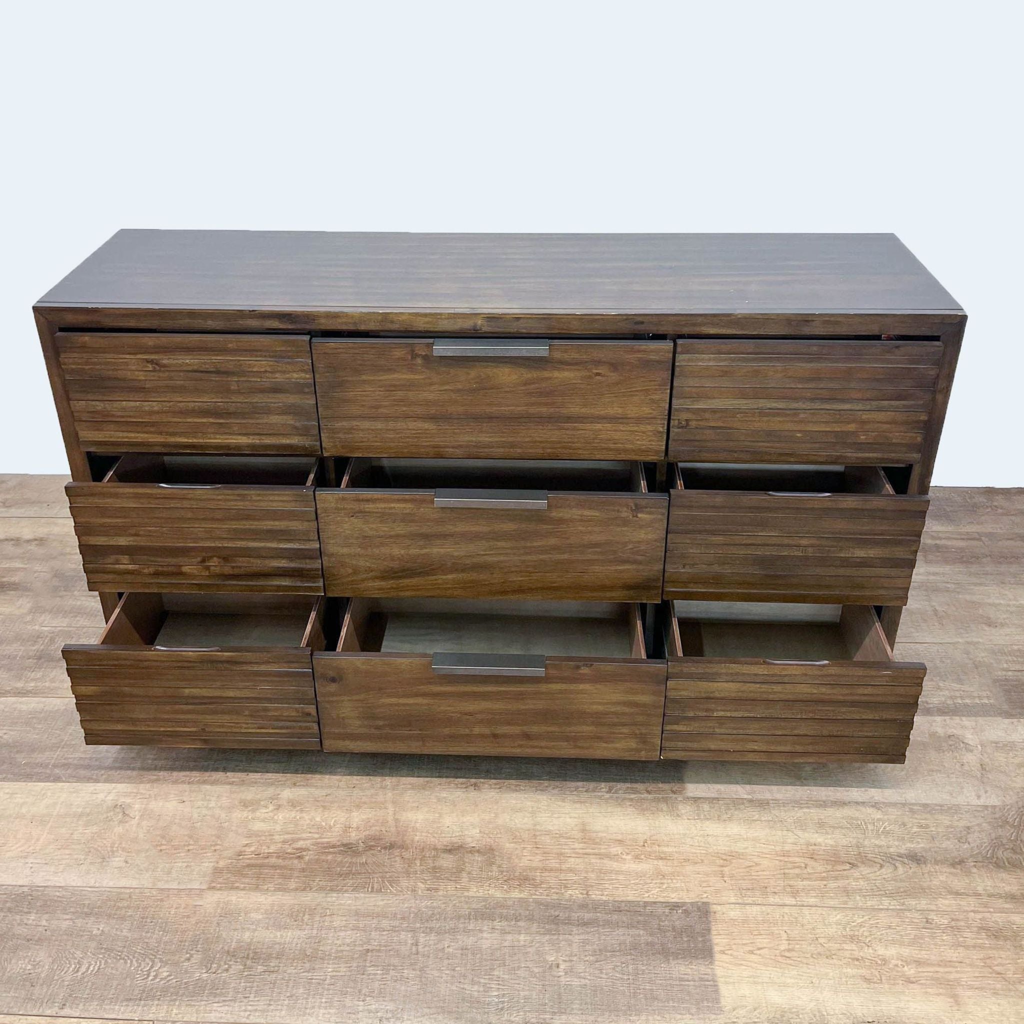 Furniture of America wood and wood veneer dresser, featuring 6 drawers with slatted fronts and metal handles, drawers open.