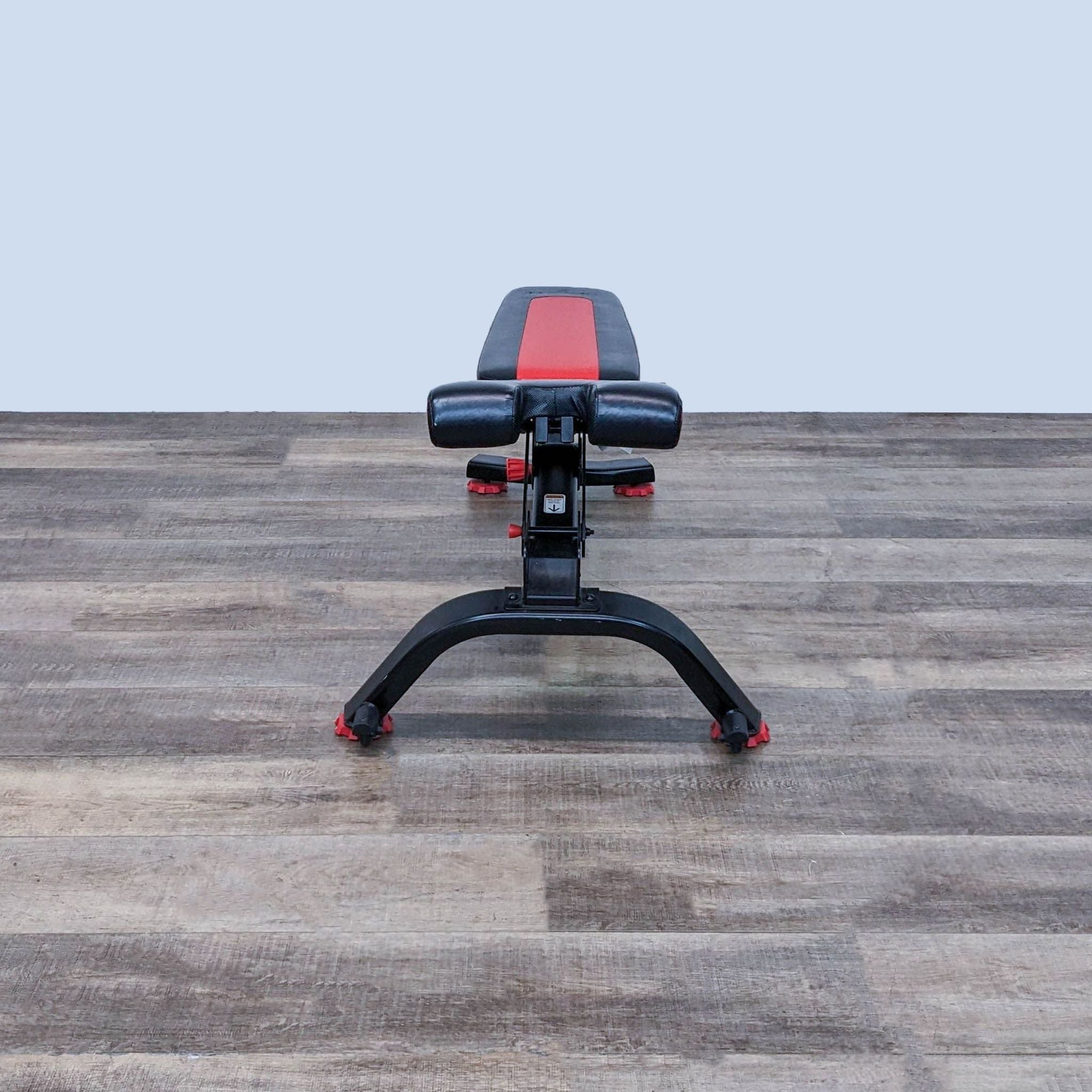 Alt text 2: Adjustable Bowflex gym bench shown at an incline angle, emphasizing its versatility for various exercises.