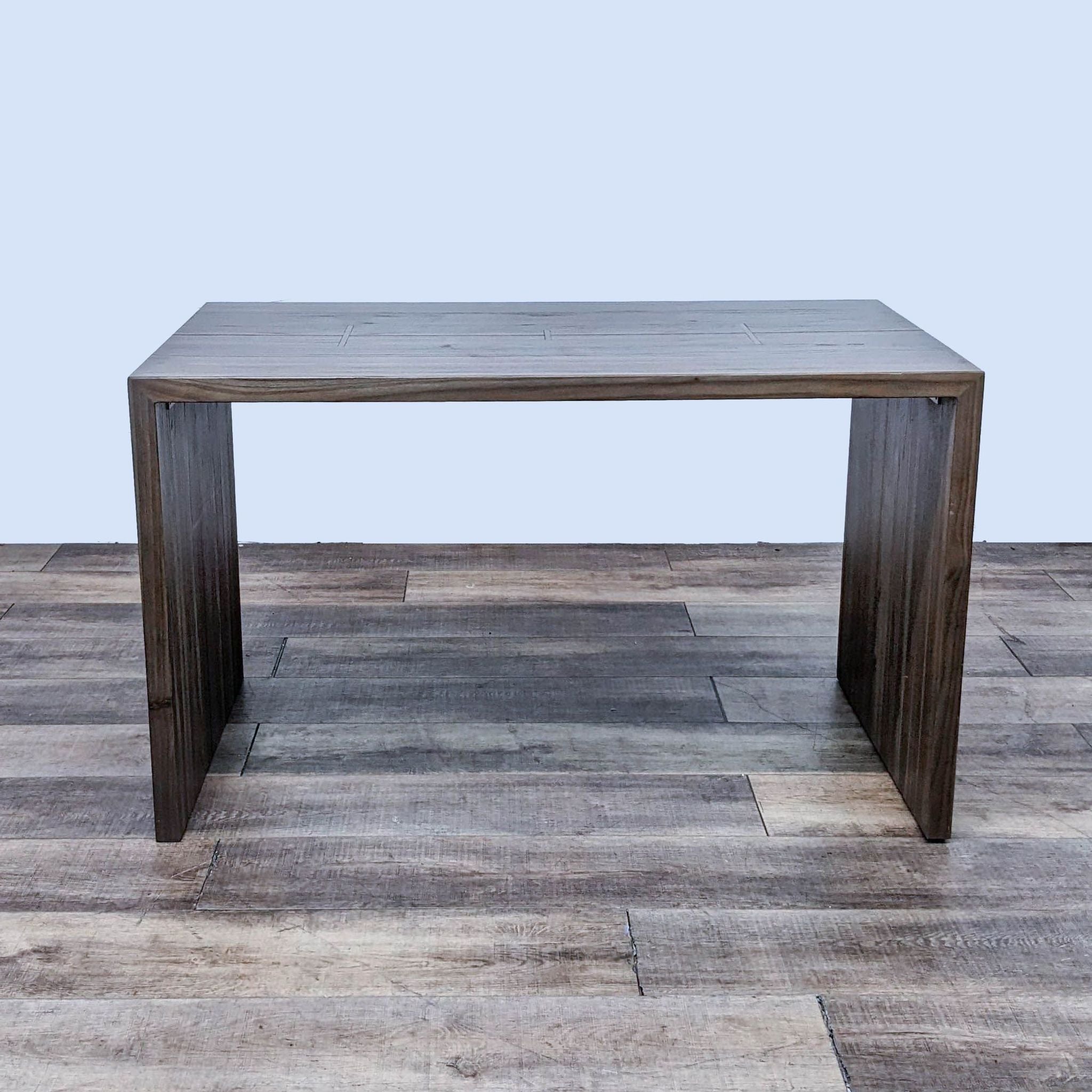 Crate & Barrel exclusive Maxwell Waterfall dining table, made from elm wood with brass inlay bands.