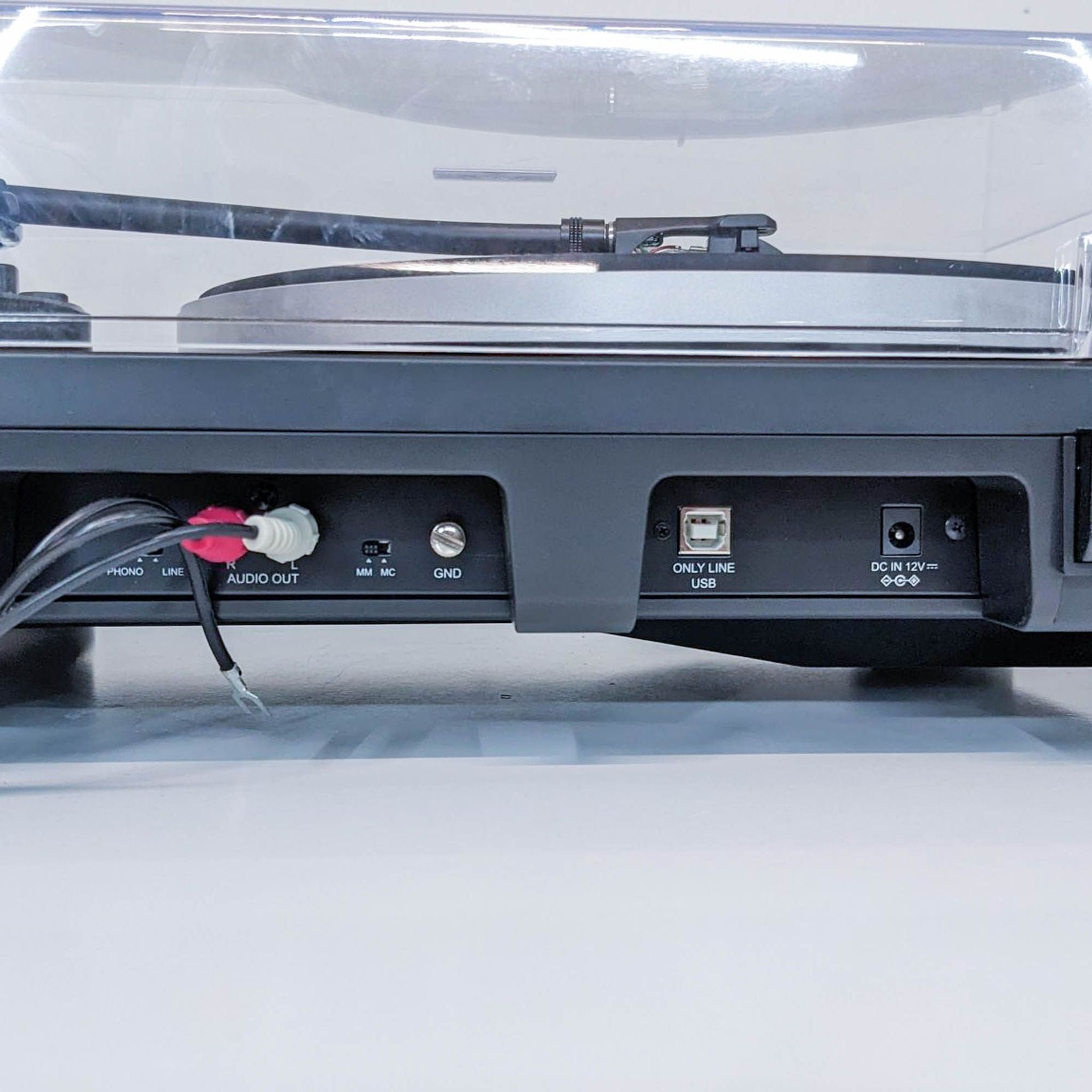 Rear view of an Audio-Technica turntable showing audio outputs, a USB port, and power connector.