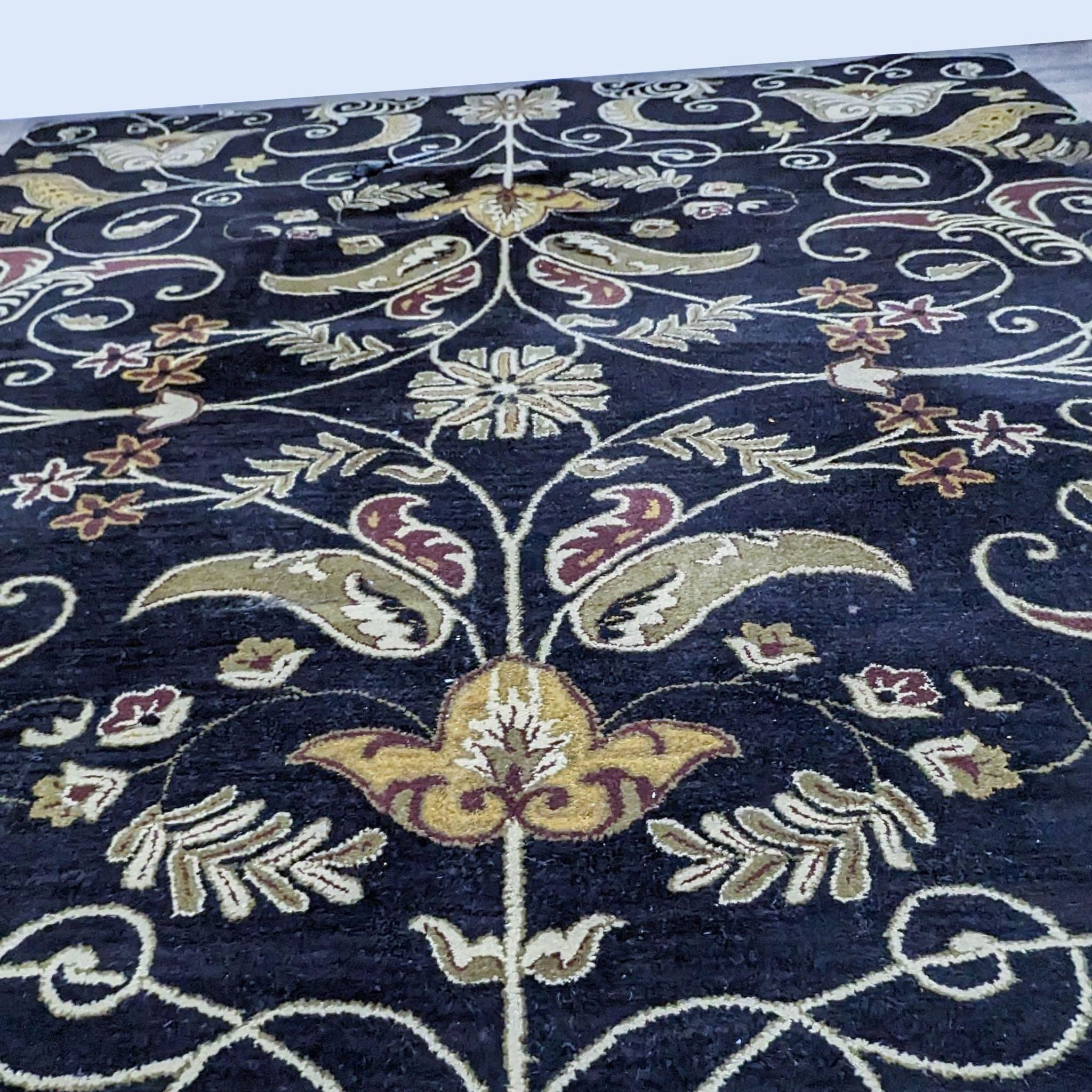 Alt text 2: Close-up of an Ansley wool rug by Home Decorators showcasing its detailed weave and rich color palette of gold, ivory, and burgundy on a dark base.