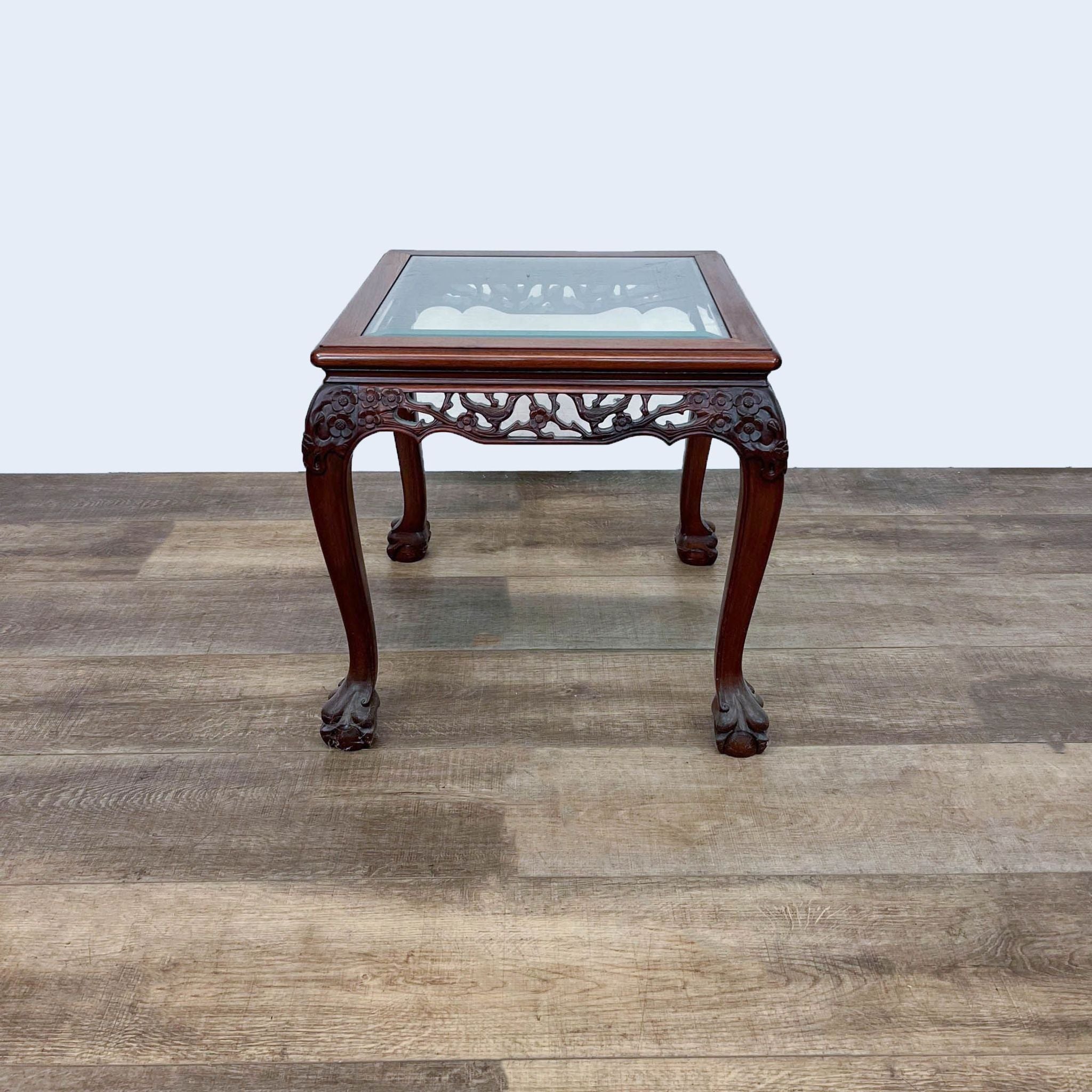 Elegant Reperch end table in the Chinese Chippendale style, showcasing detailed legs with ball and claw design and a glass inset top.