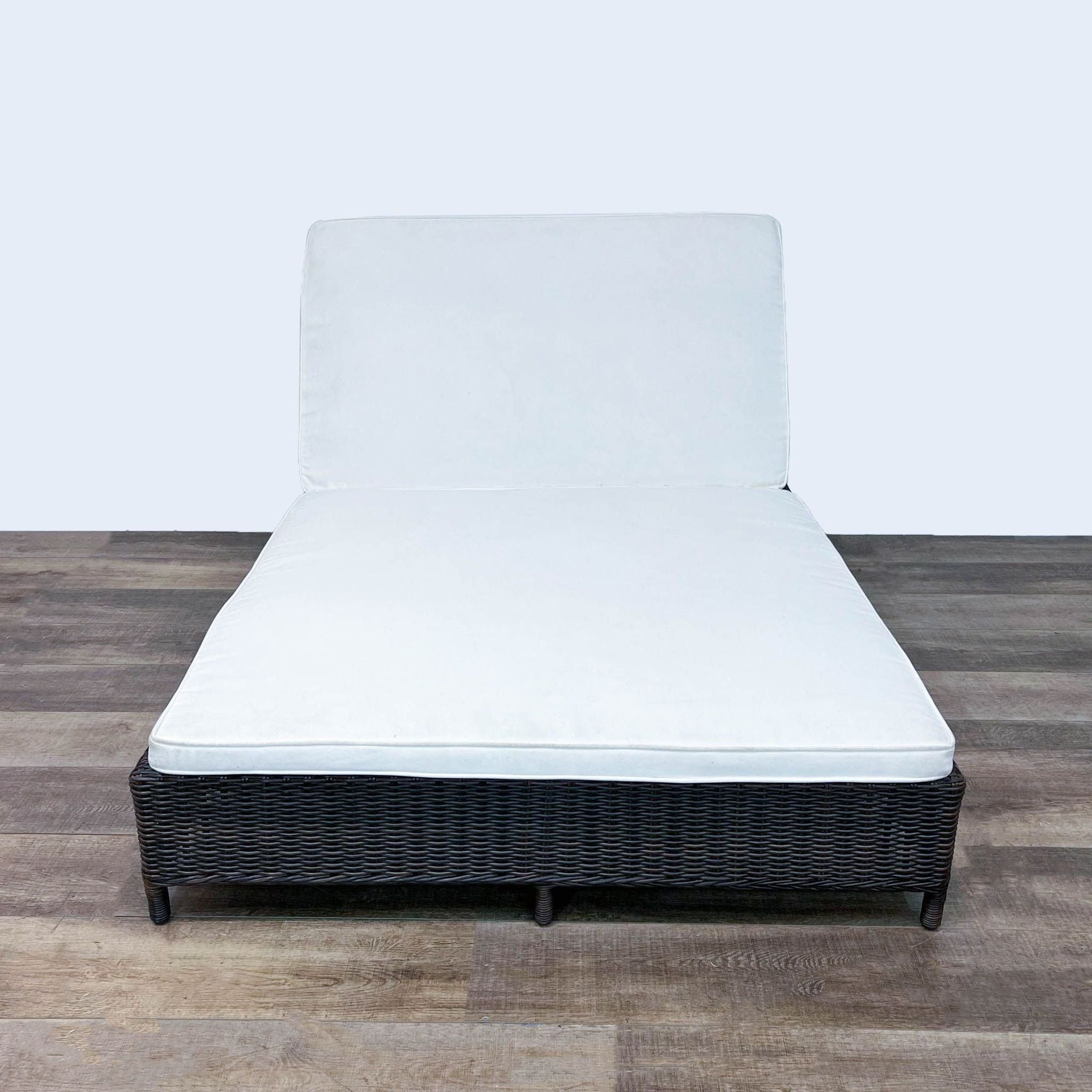 Pottery Barn resin wicker double chaise with an adjustable backrest and white cushion on an aluminum frame.