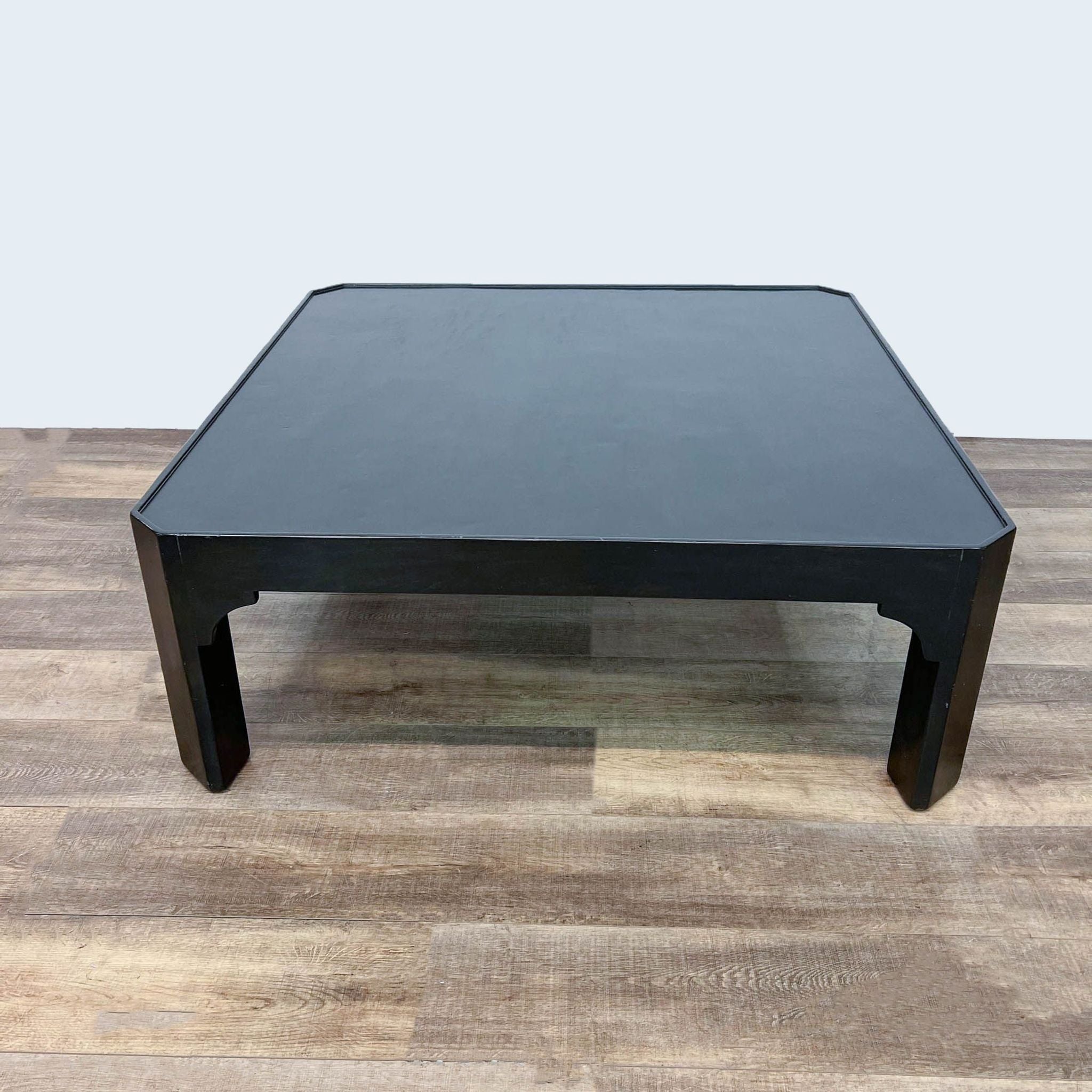 Square black coffee table by Dennis & Leen, with a minimalistic design, set against a neutral backdrop.