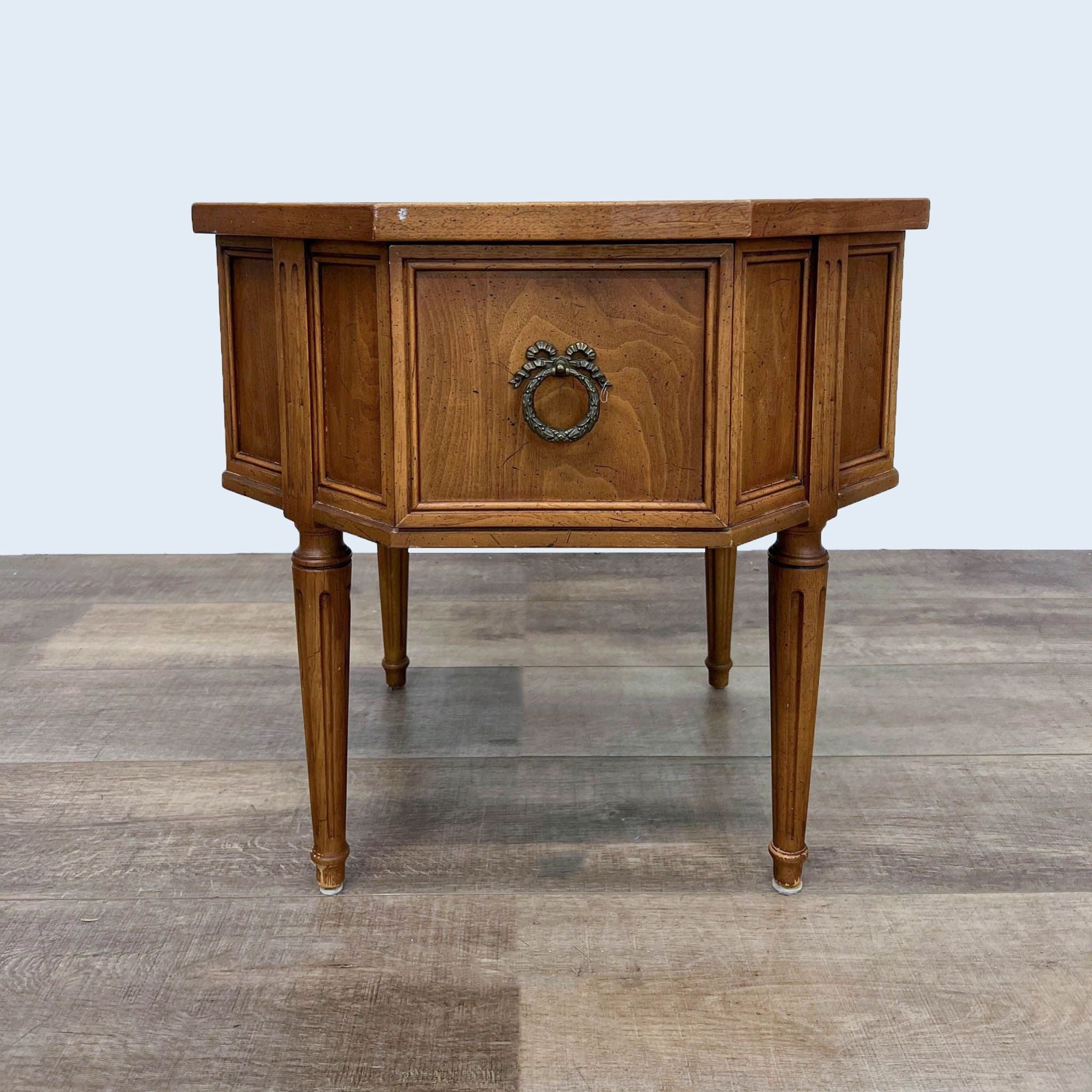 Reperch brand hexagonal wooden end table with a single ornate drawer handle, standing on tapered legs.