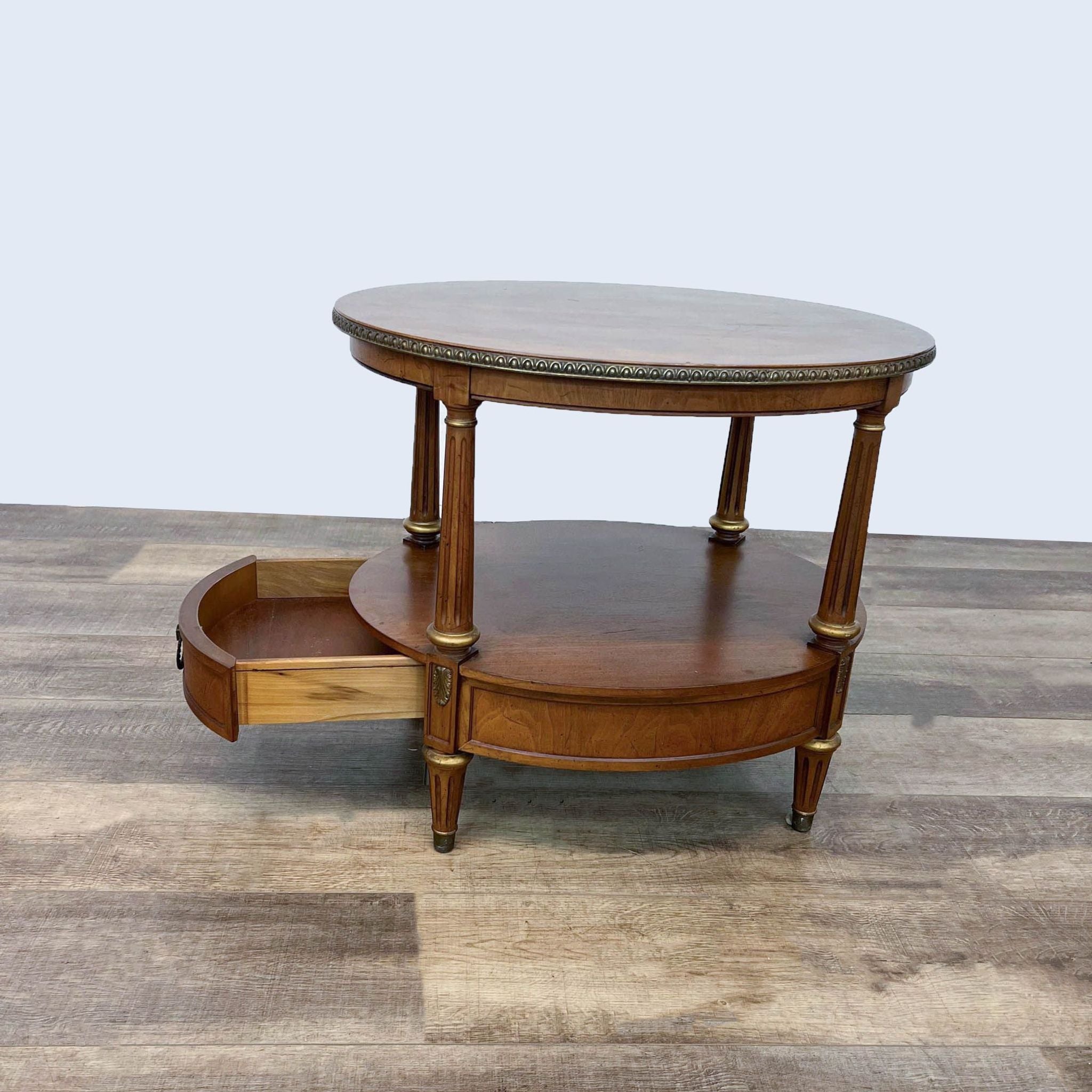 Henredon end table showing open drawer, fluted legs, detailed top edge, on a wooden floor.