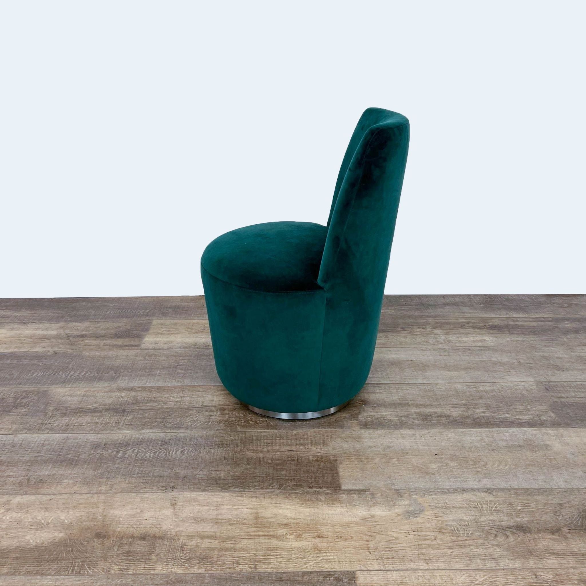Alt text 2: Comfortable Ofelia dining chair with recessed swivel base, featuring tapered back in deep green velvet upholstery, by Crate & Barrel.