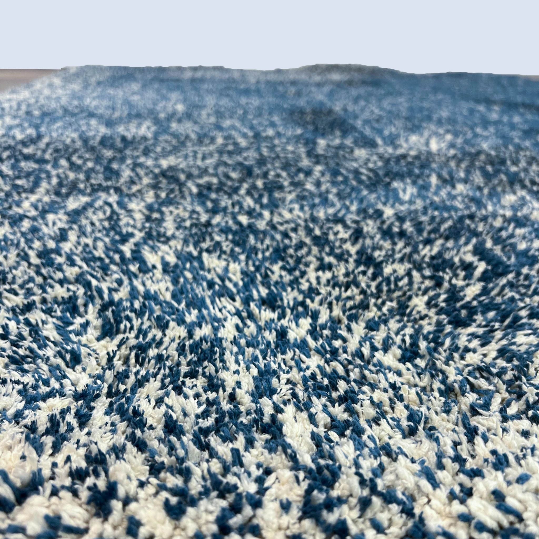 Close-up of the KAS Bliss rug texture, emphasizing the soft polyester weave and durable, stain-resistant 1" pile in blue and white.