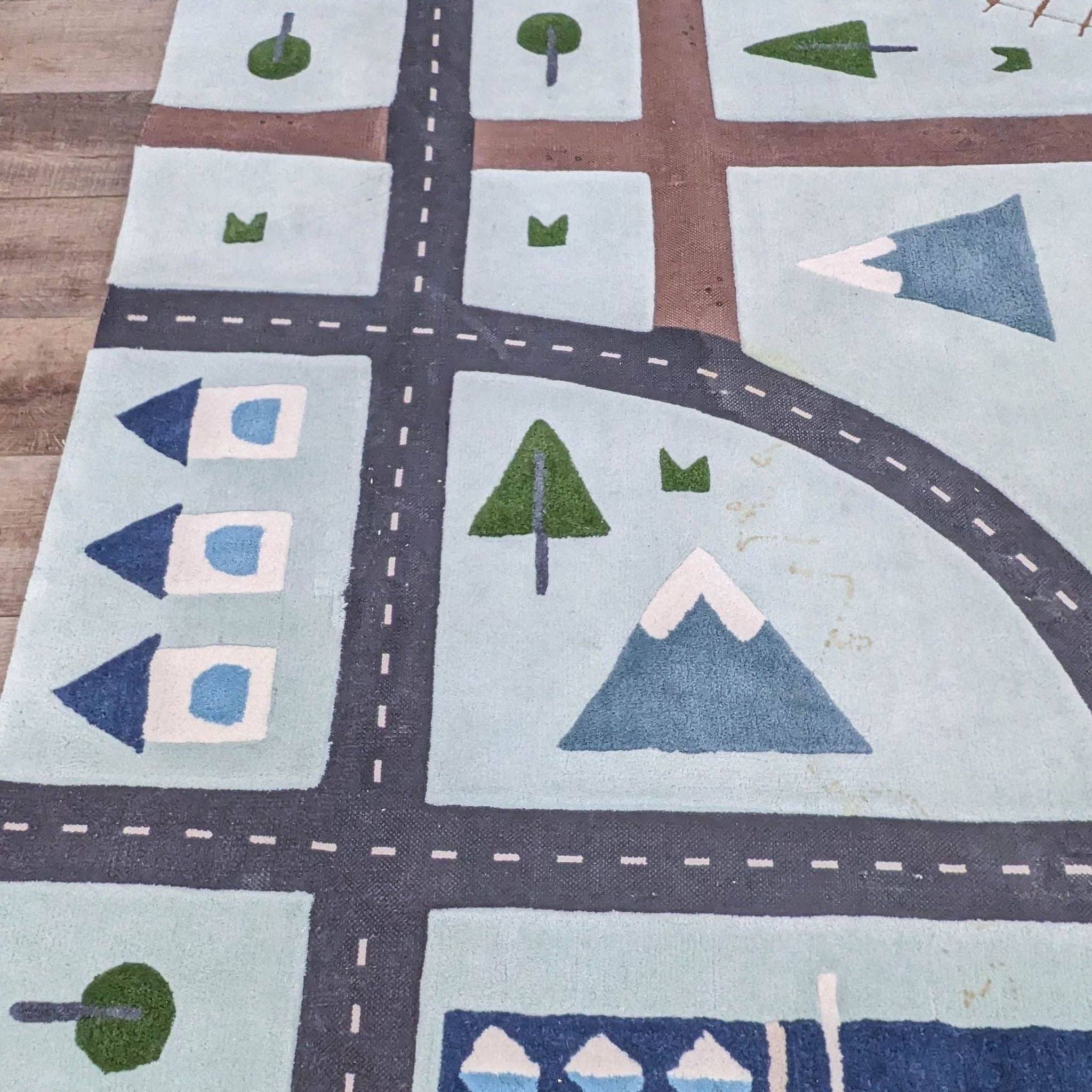 2. Close-up of Crate & Barrel's City Car Kids Area Rug showing detailed street design and textured wool, perfect for children's imaginative playtime.