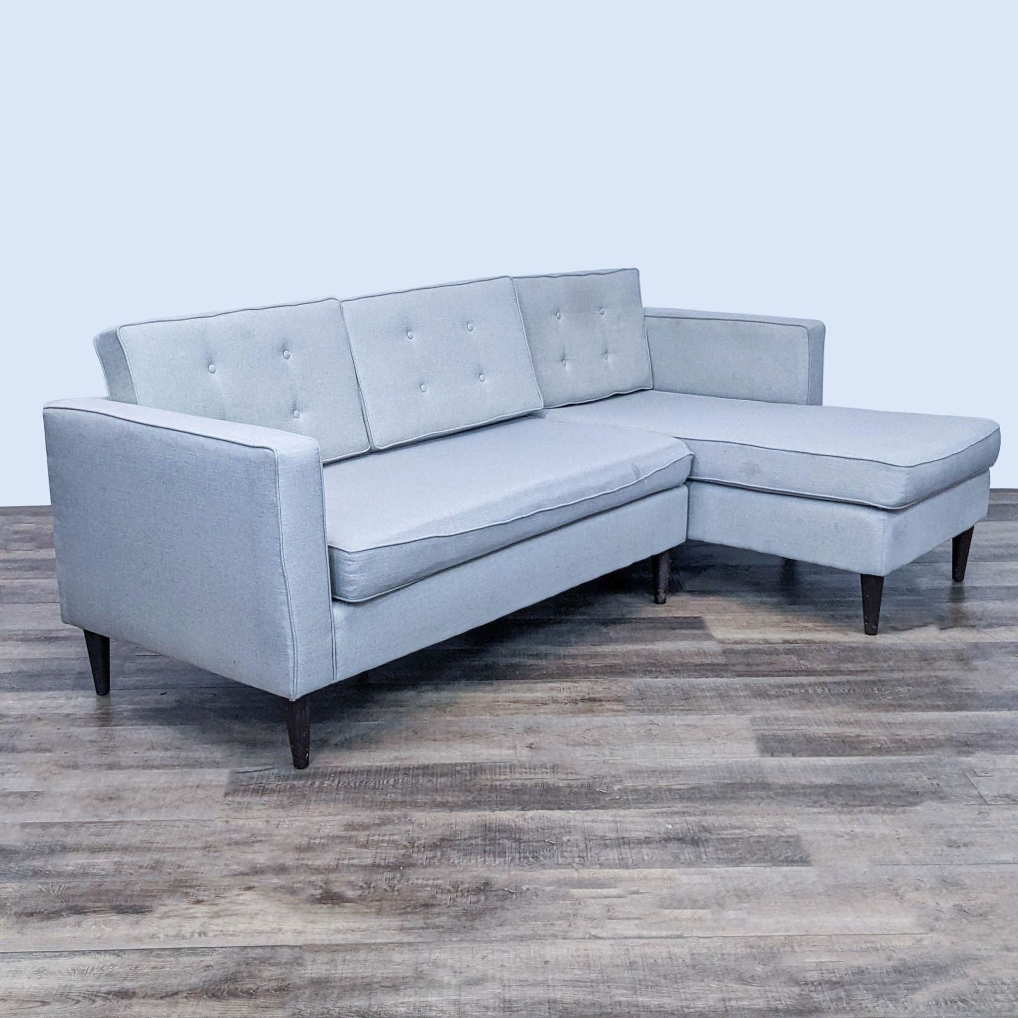 Light grey Reperch sectional couch featuring tufted cushions and sleek profile, viewed from different angles.