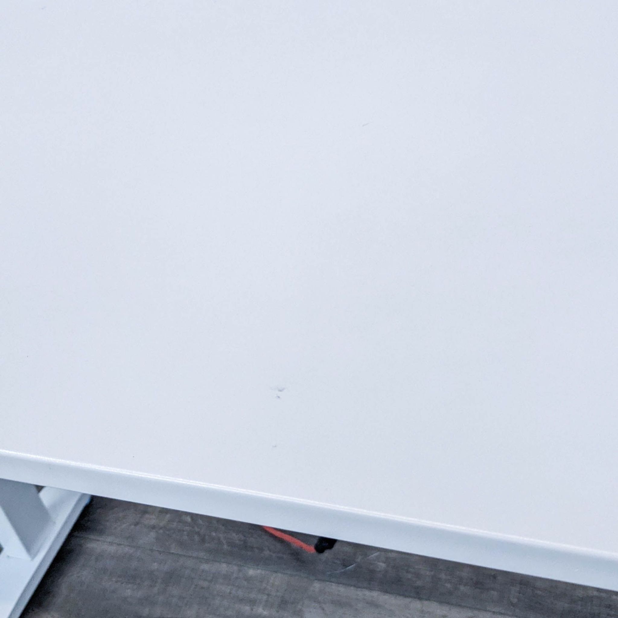 Top view of a Reperch white motorized adjustable-height desk, focusing on the tabletop and part of the frame.