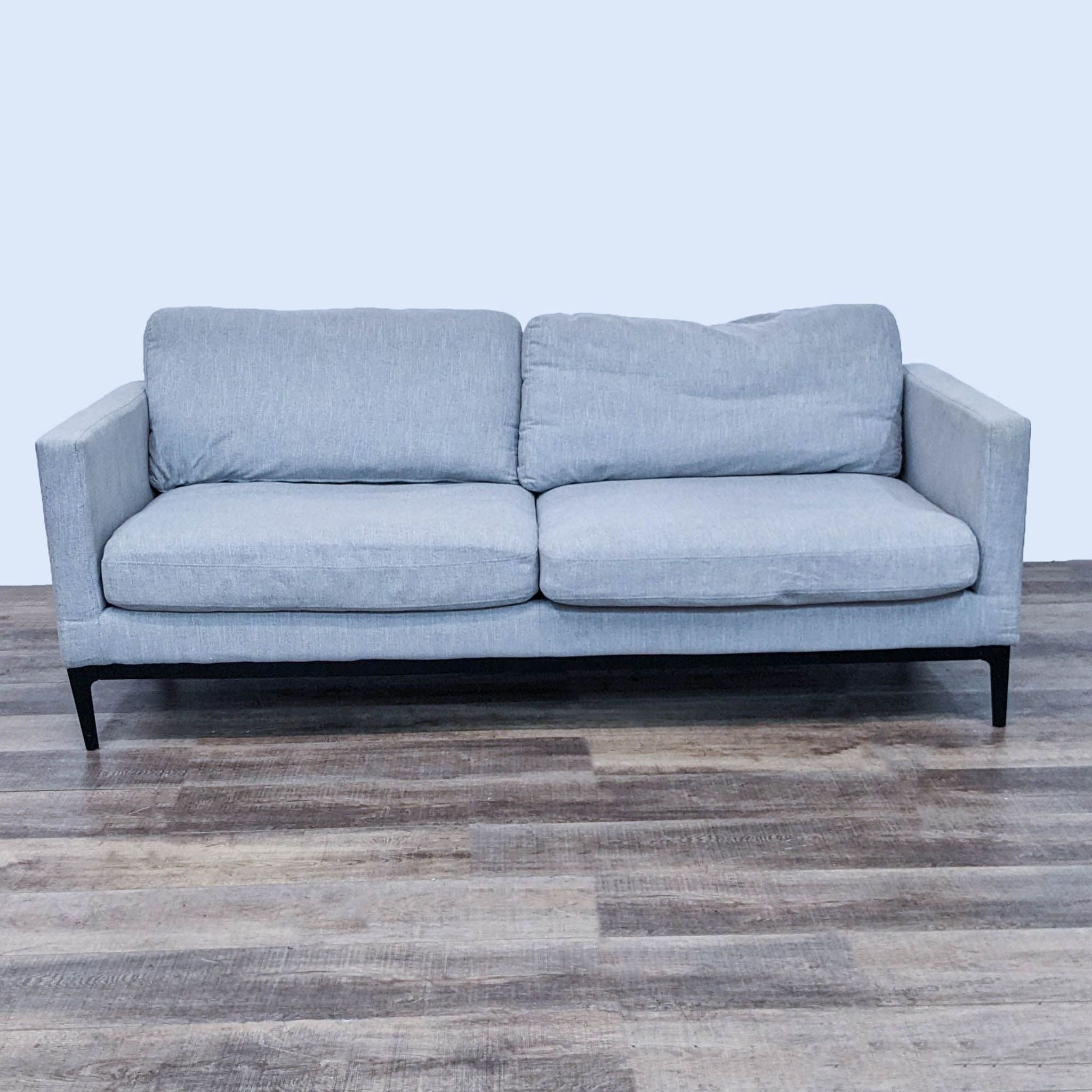Alt text 1: Three-seat Coaster sofa with a clean line design, gray upholstery, narrow arms, and metal frame feet against a wooden floor.