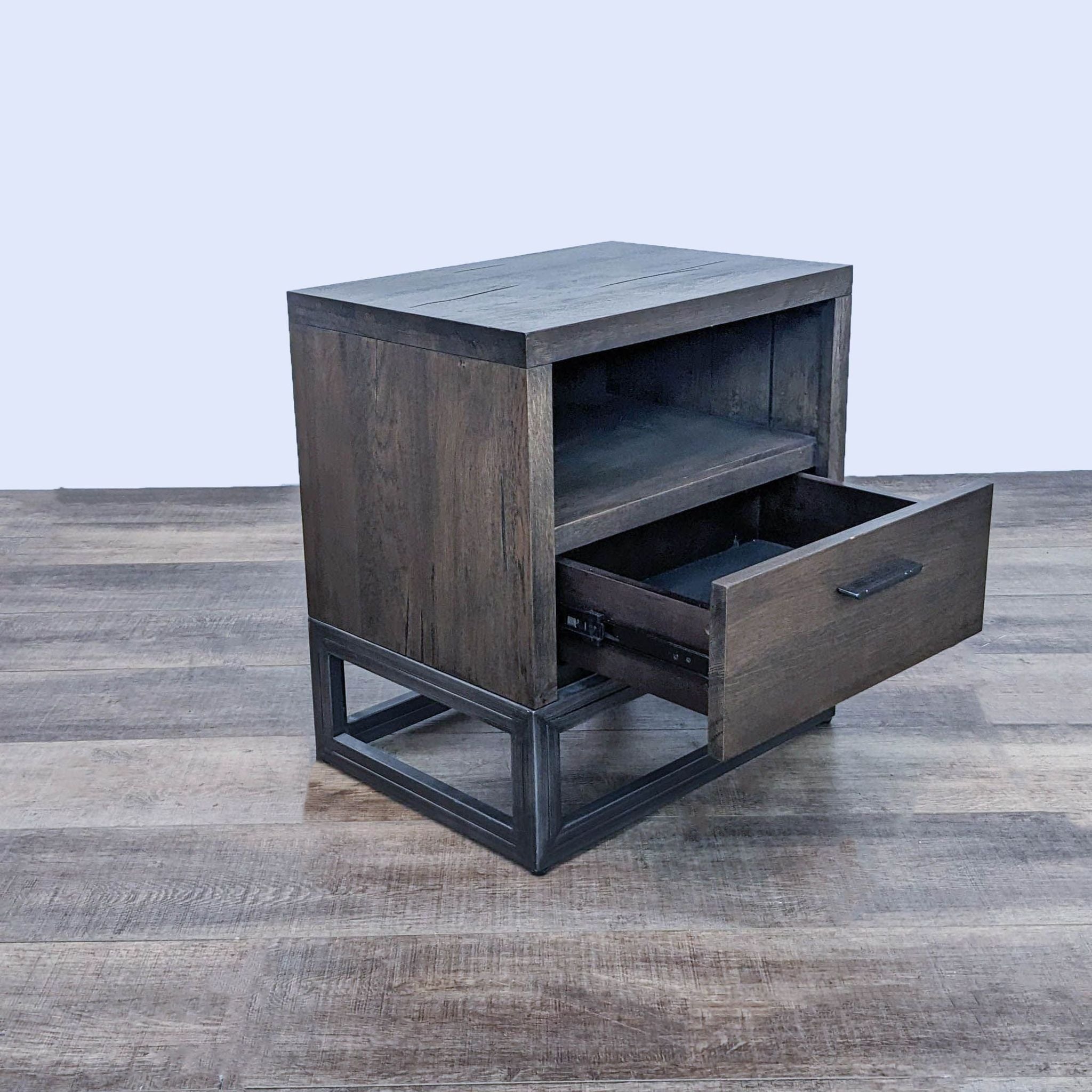 End table by Reperch featuring a metal frame, with a drawer partially open revealing interior space.
