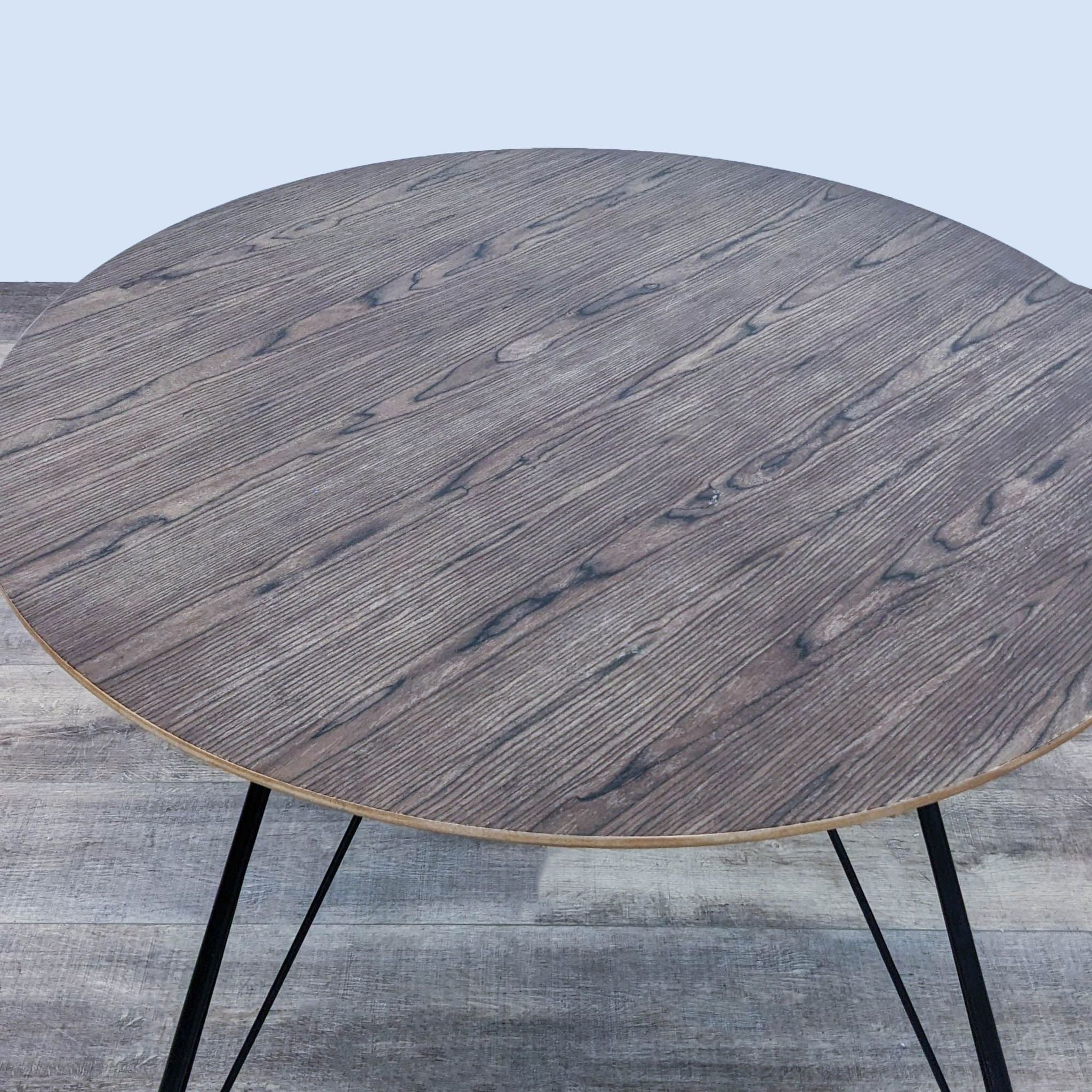 2. Modway Satellite dining table featuring a circular wood grain top and sleek black hairpin legs, shown from a top-angle view.