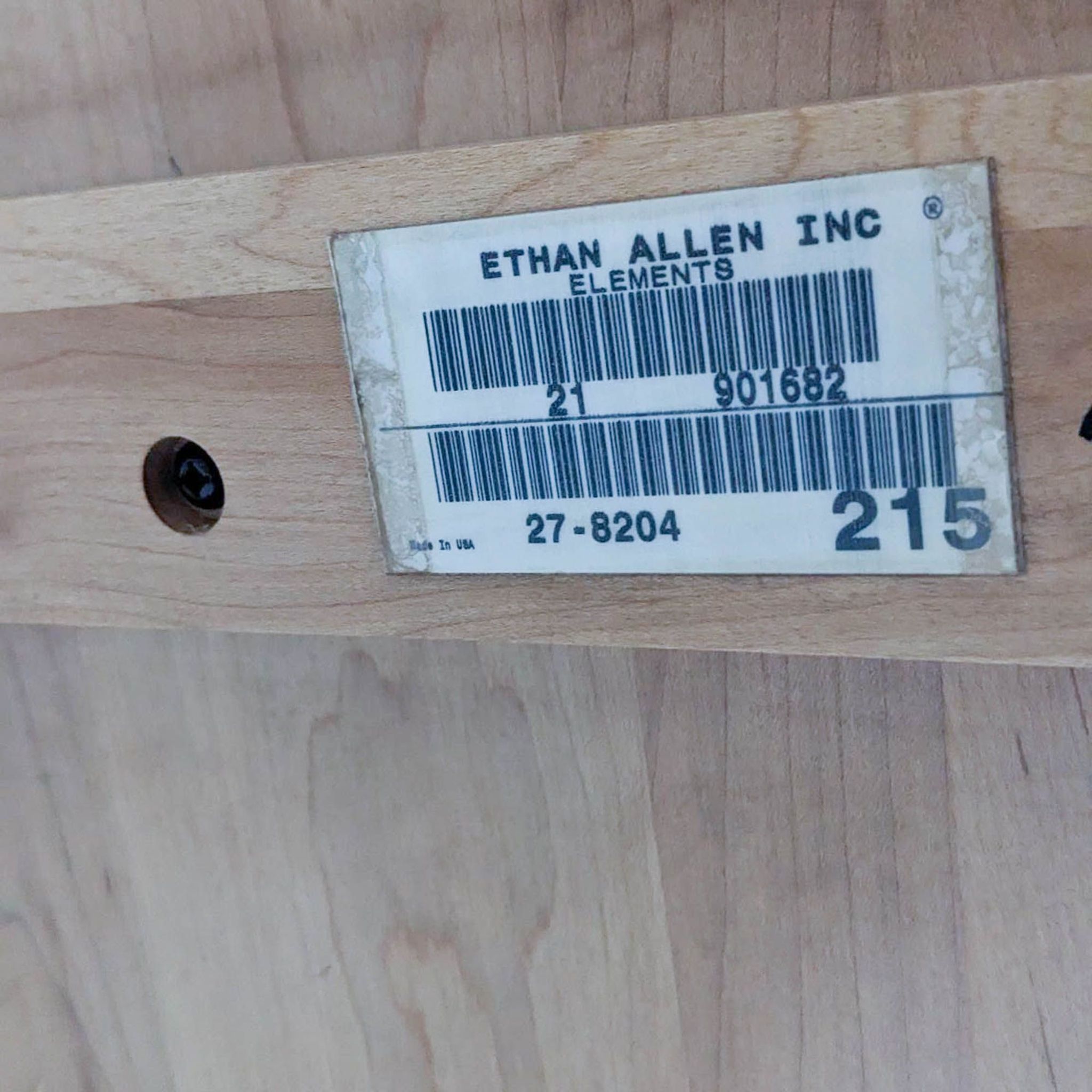 Label on a maple end table showing "Ethan Allen" brand details, with barcode and model number.