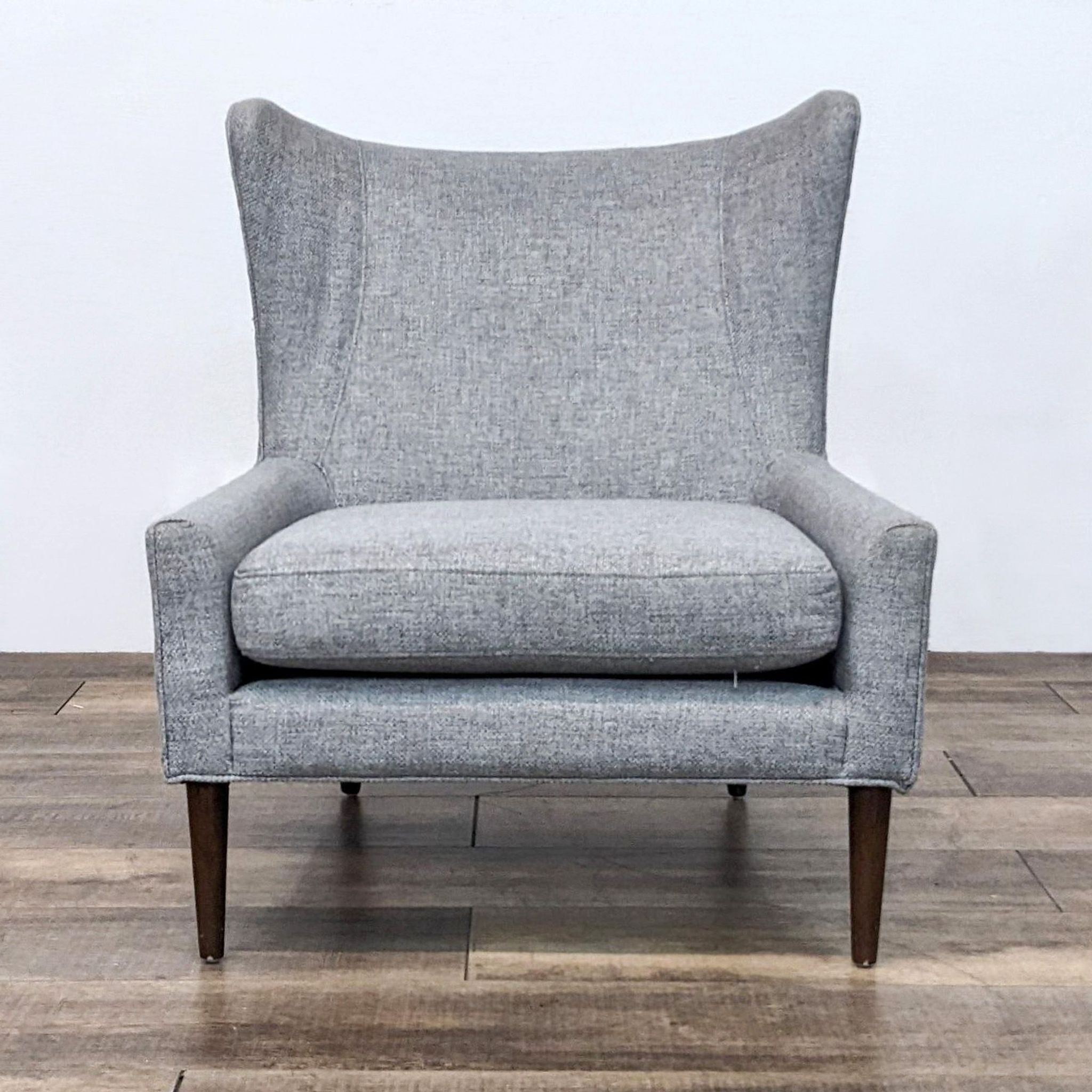 Modern Marlow chair by Four Hands, showcasing sleek lines with a high back, wing chair design, and tapered wood legs.