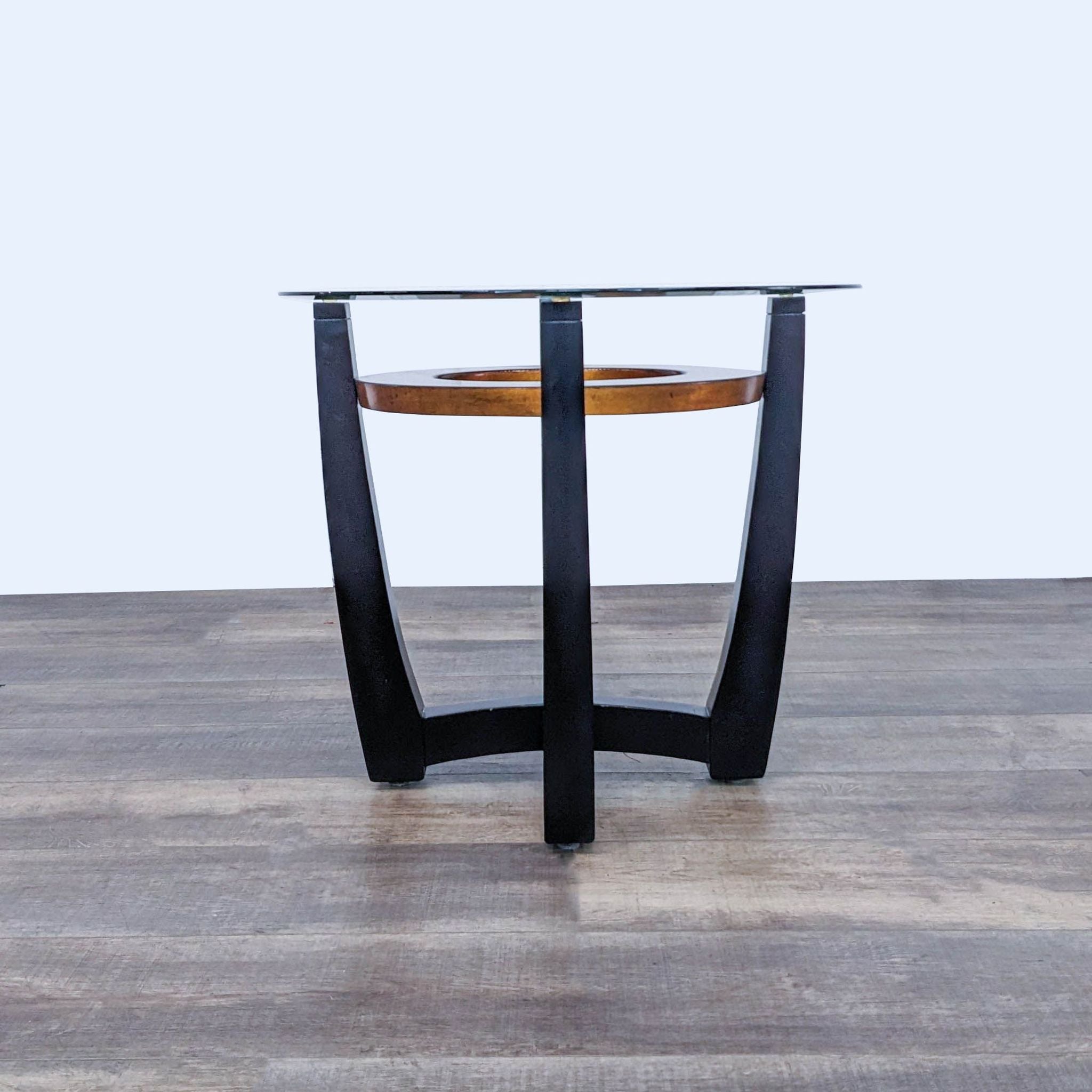 Reperch brand end table with wood base and glass top, set against a white background on a wooden floor.