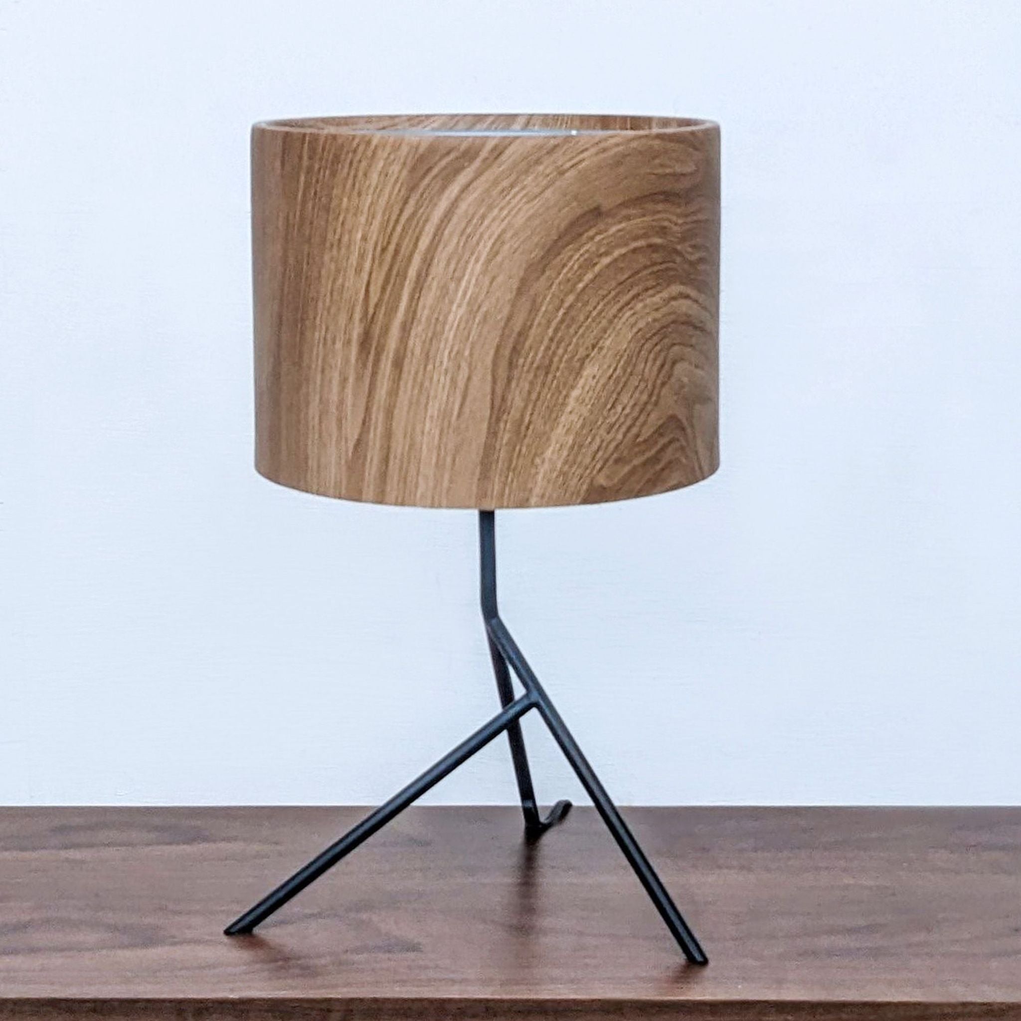 Alt text 1: Reperch brand modern table lamp with a wooden shade and a black tripod base on a wooden surface.