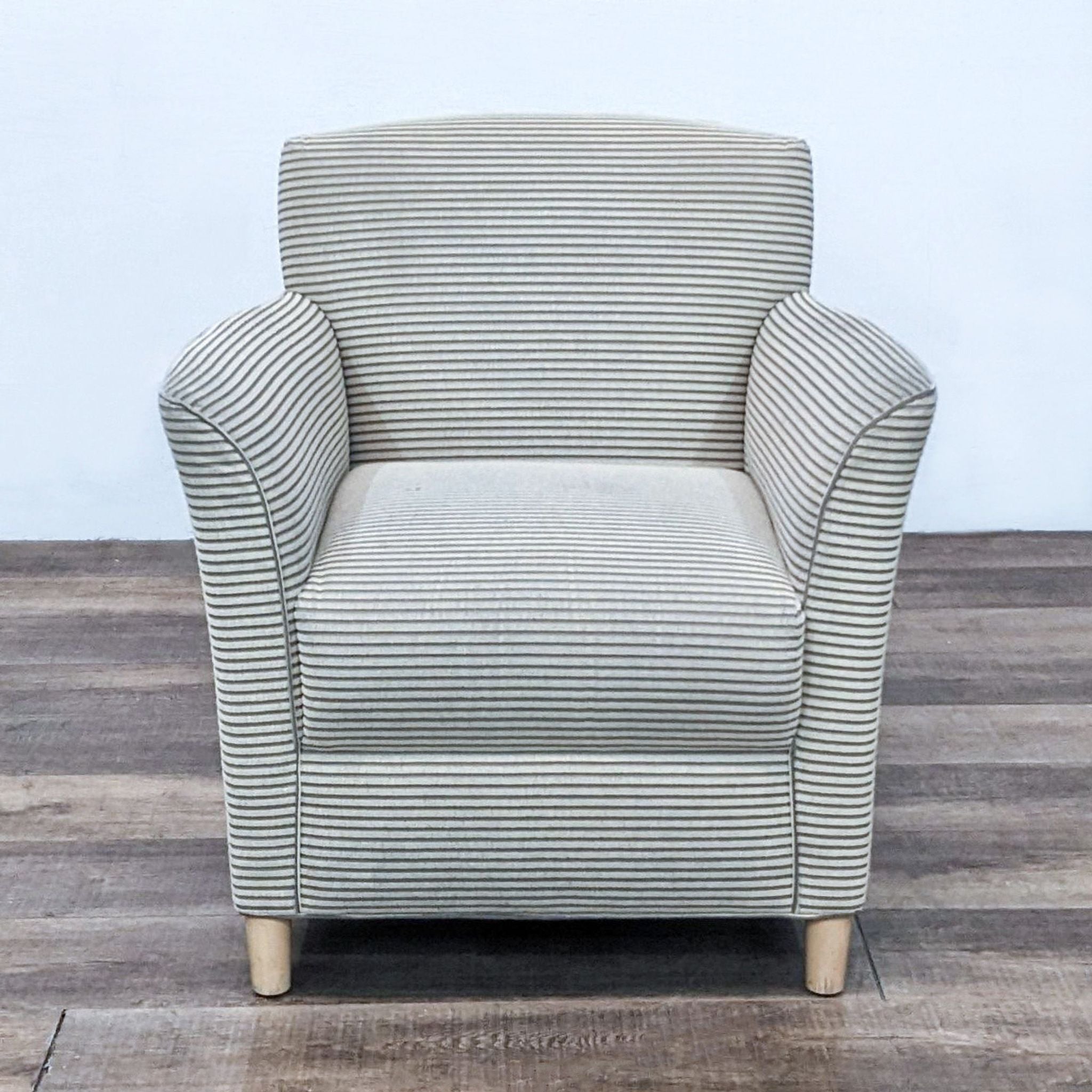 Contemporary Bernhardt club chair with rolled arms, striped upholstery, and tapered wooden feet viewed from the front.
