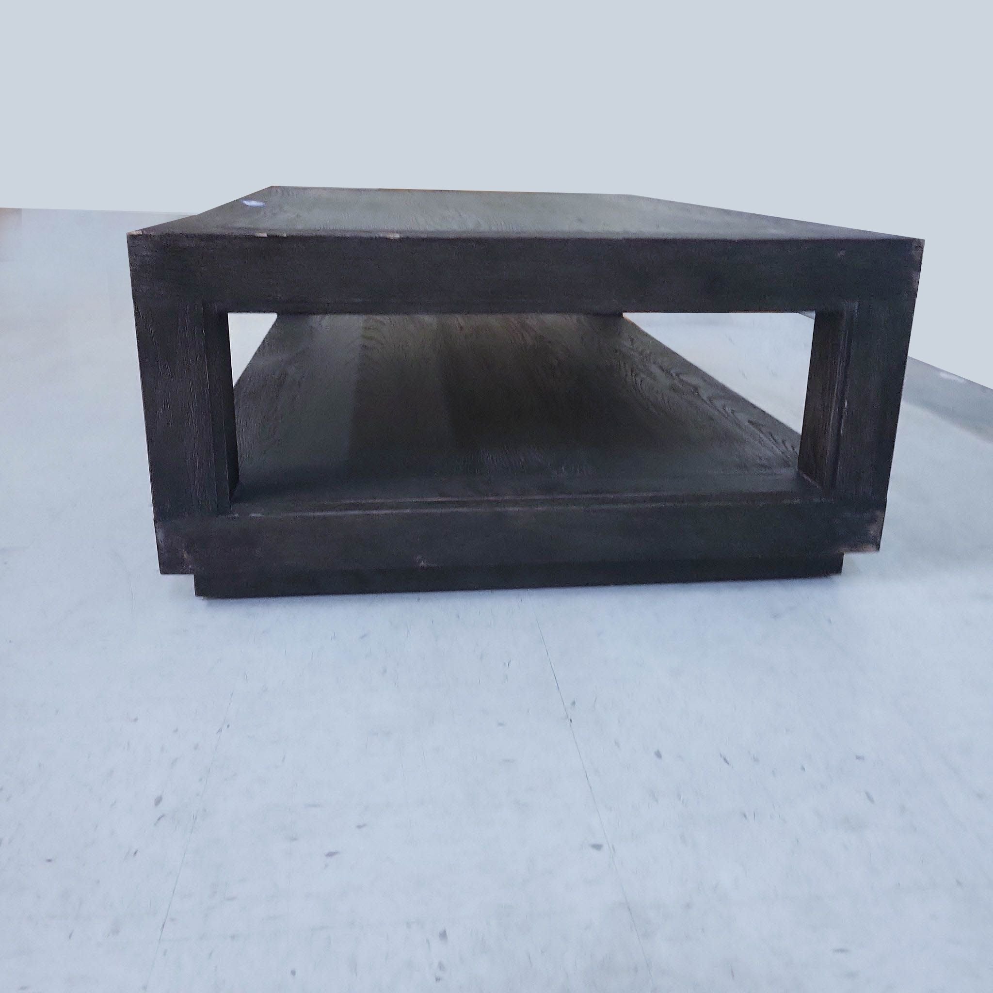 Restoration Hardware dark wood coffee table with a lower shelf, displayed on a plain background.