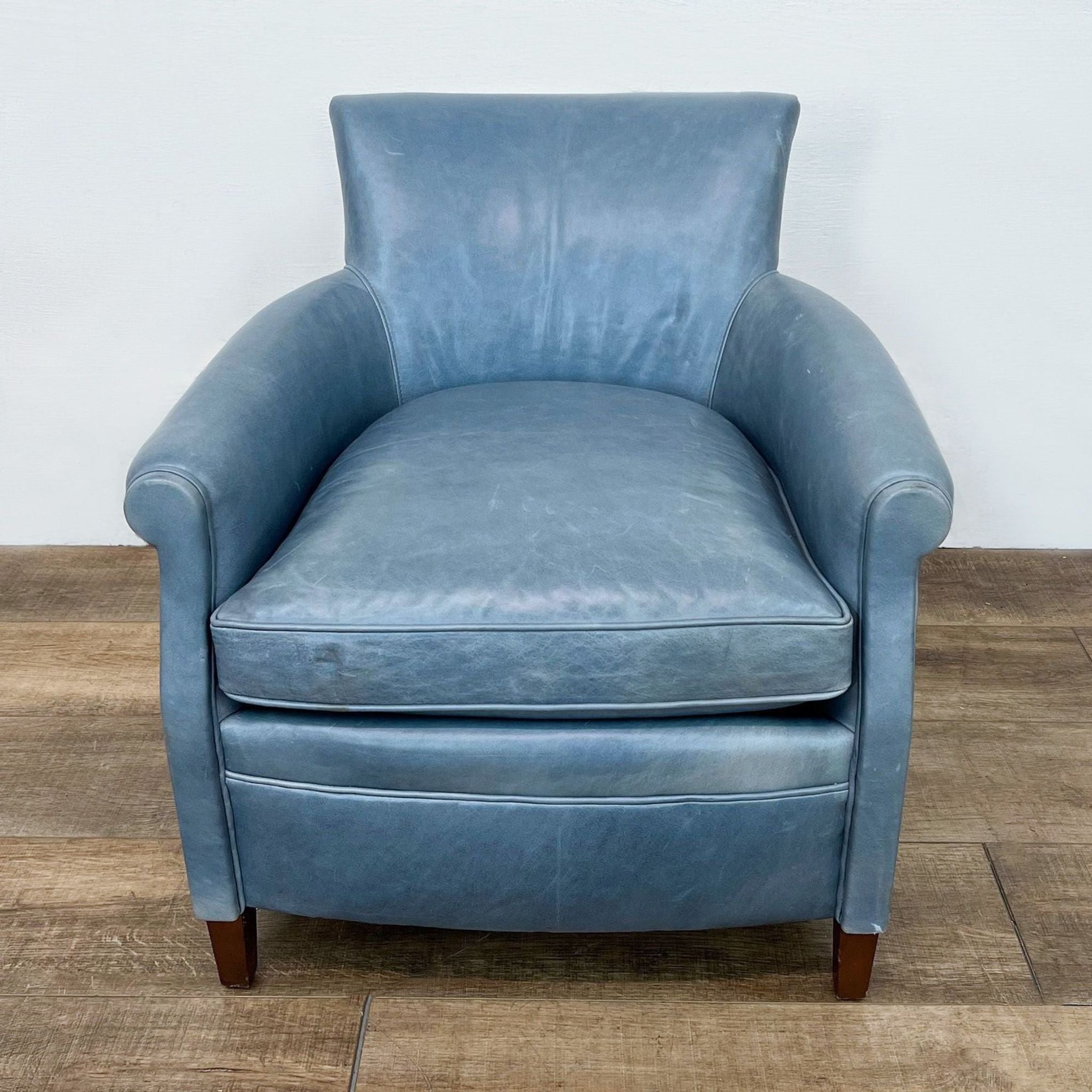 Moore and Giles 33 Original blue leather lounge chair with a solid wood frame and cushioned seat, viewed from the front.