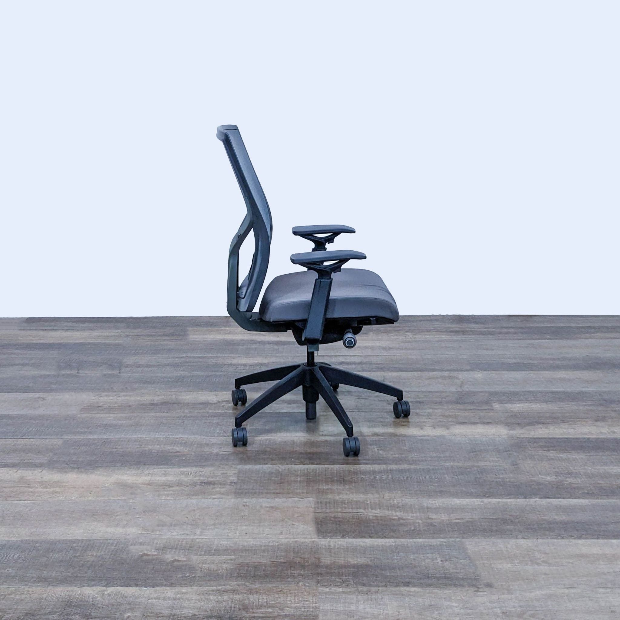 Alt text 2: Side view of a SitOnIt Torsa mesh office chair showing profile, adjustable armrest, and nylon caster wheels, against a plain background.