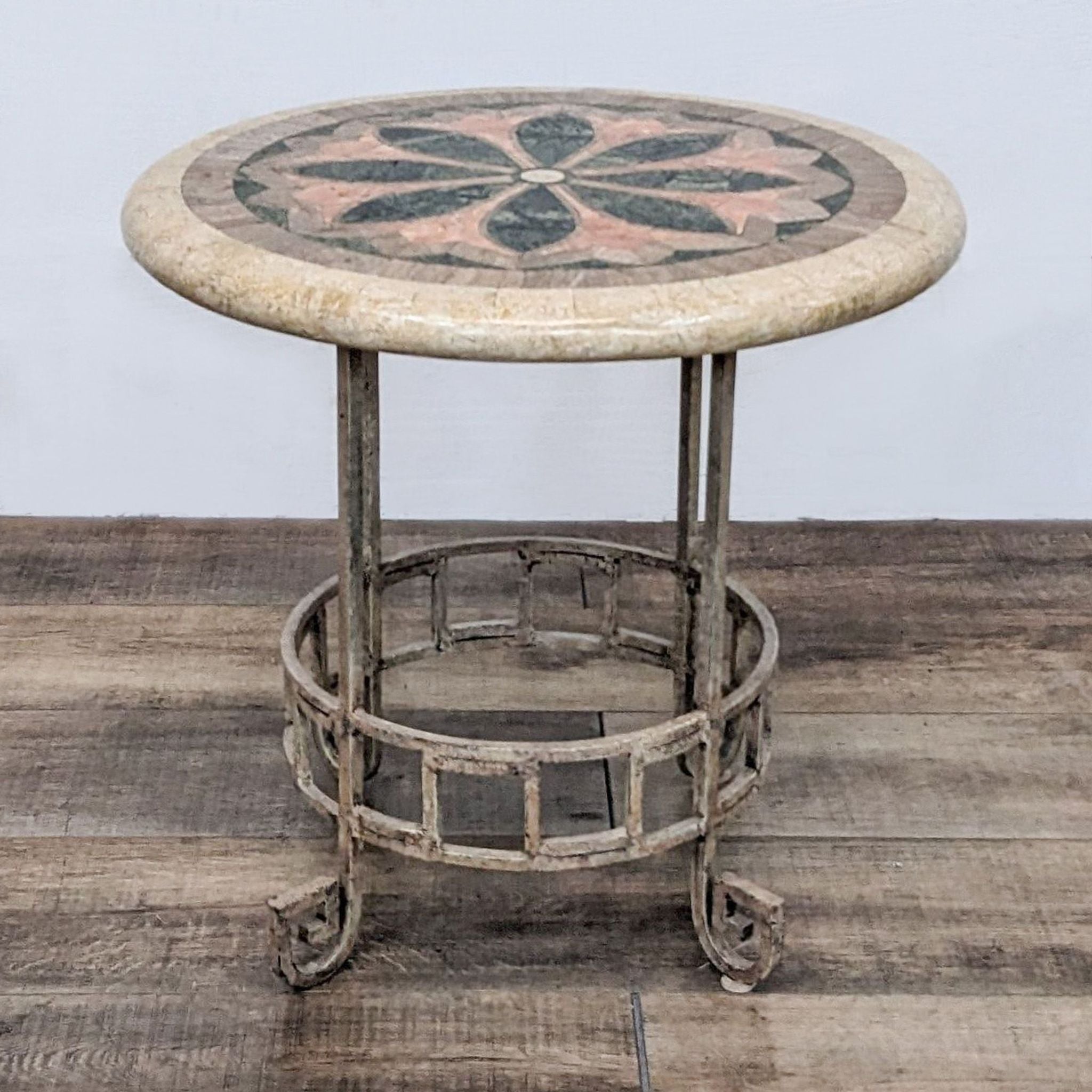 Reperch end table with a round, faux stone top featuring a decorative pattern on a metal base with lower shelf.