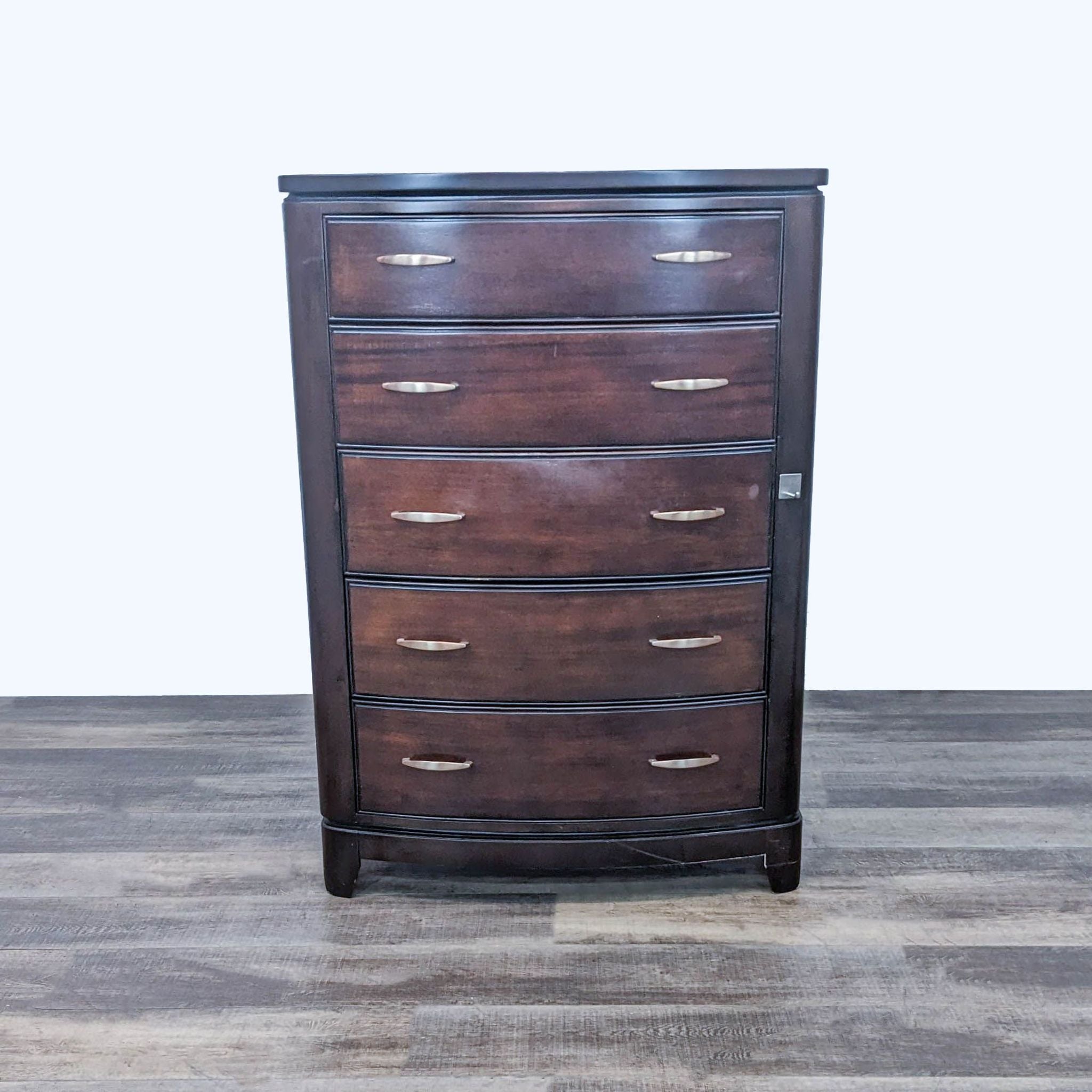 Front view of a Reperch contemporary curved chest of drawers with five drawers and brass pulls.
