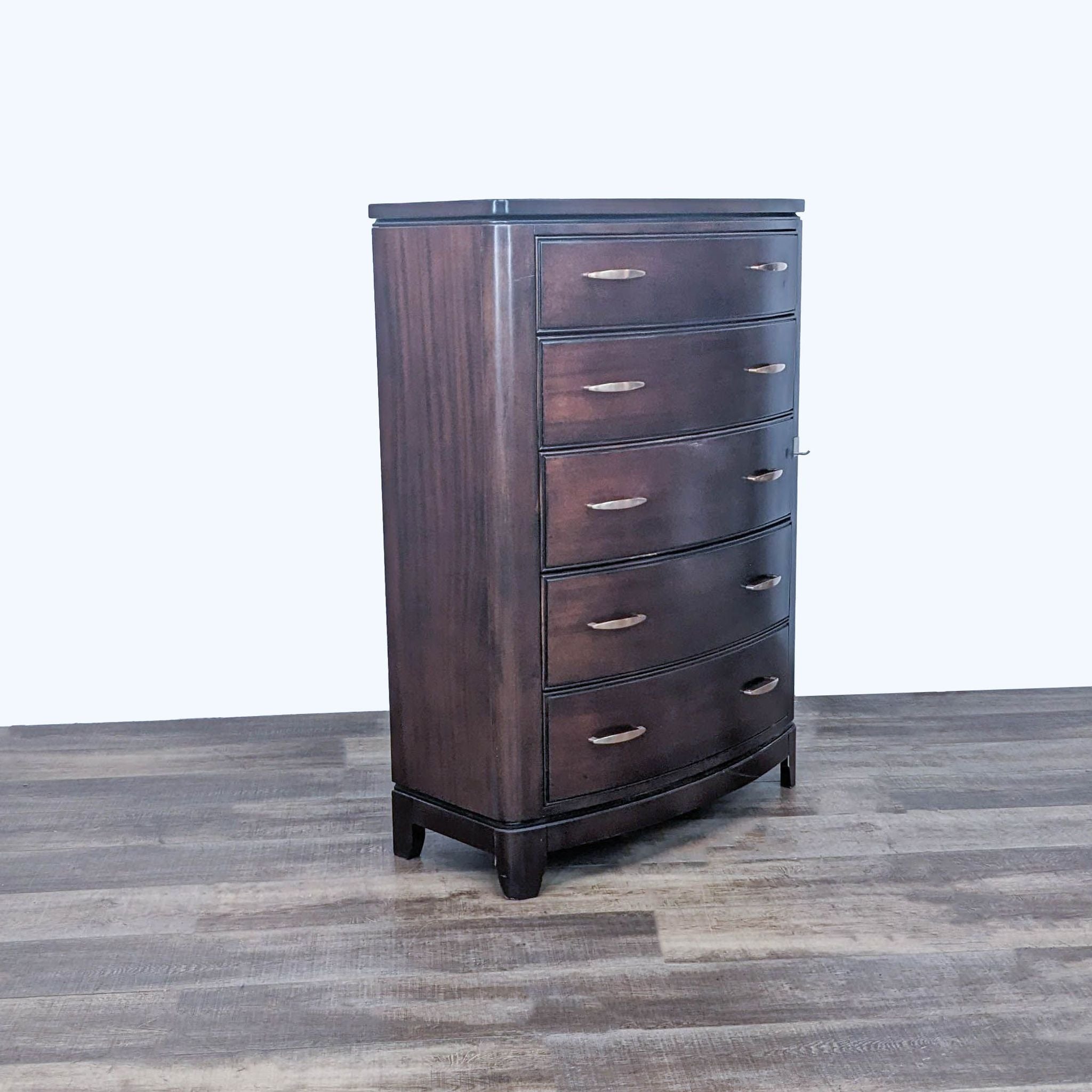 Side view of a dark brown Reperch dresser with a curved front and five drawers with metal glides.