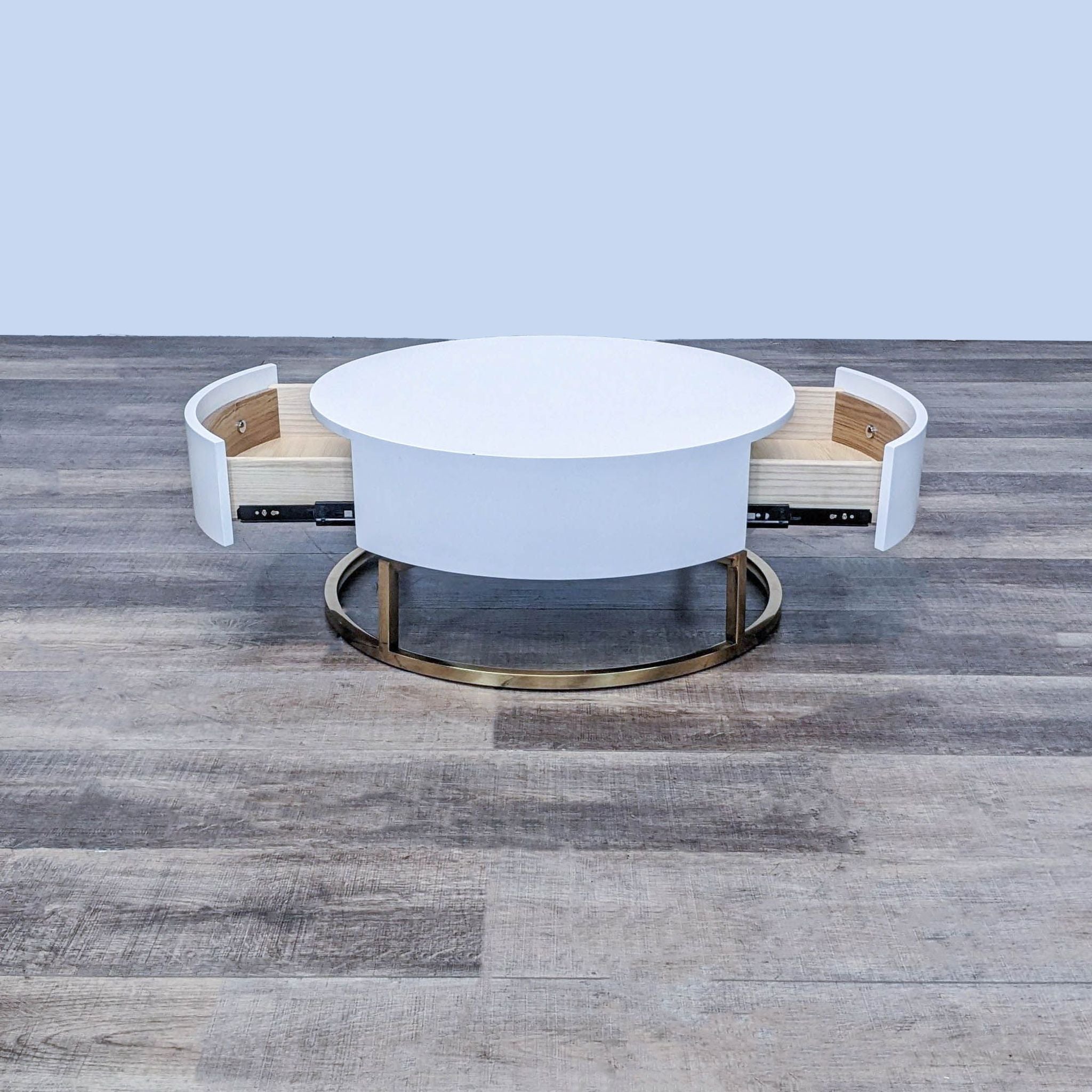 Alt text 2: Reperch coffee table with open drawers revealing storage, circular white top, on a wooden floor.